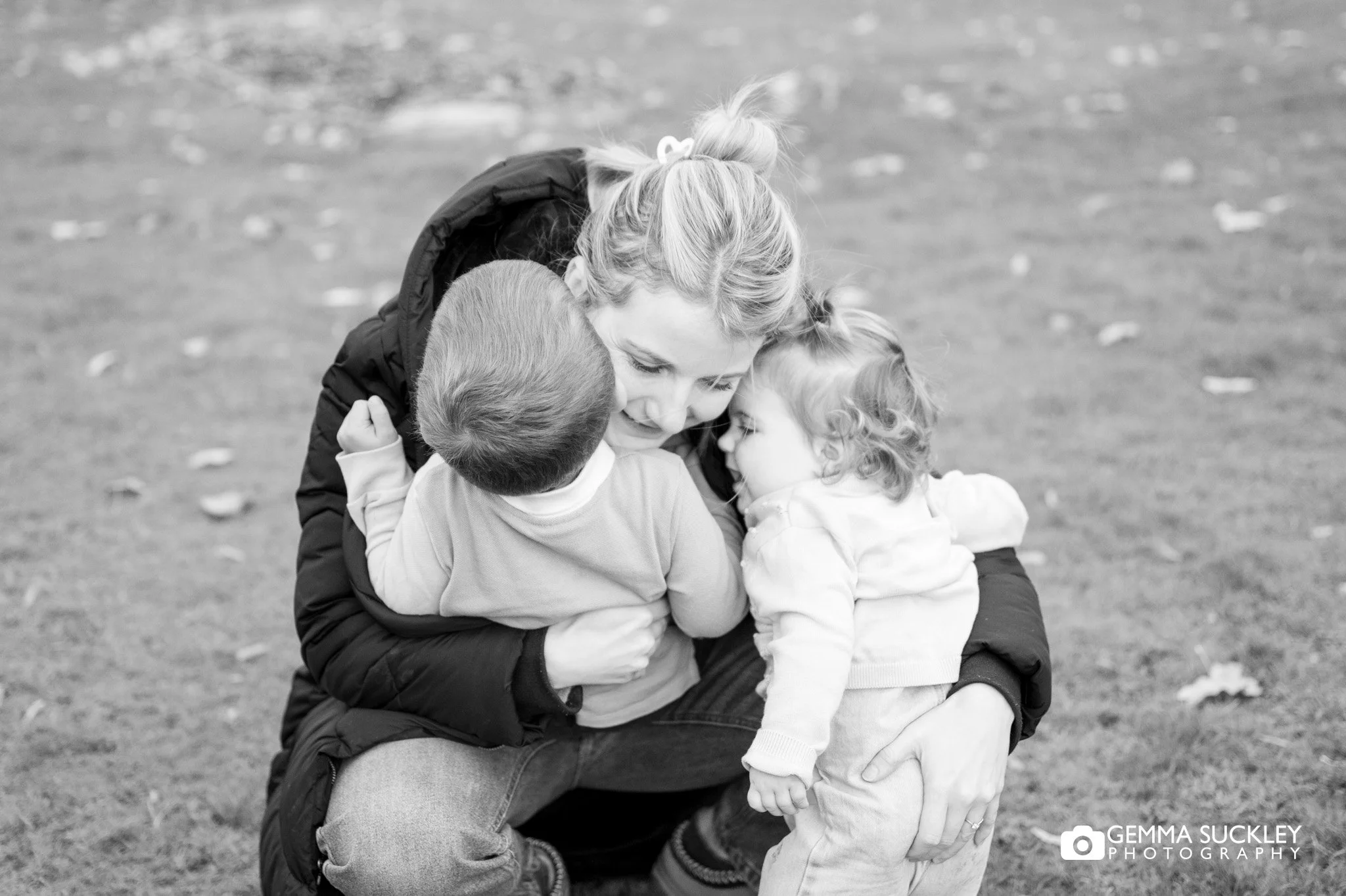 mum cuddling her two toddlers