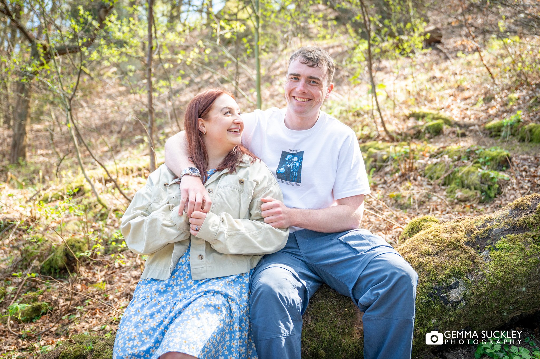 engaged couple hugging at the otley chevin