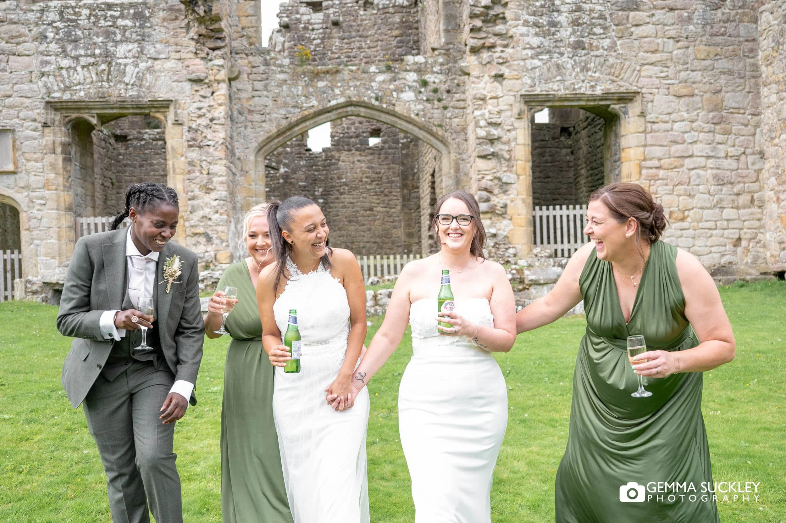 bridal party laughing with drink outside barden tower