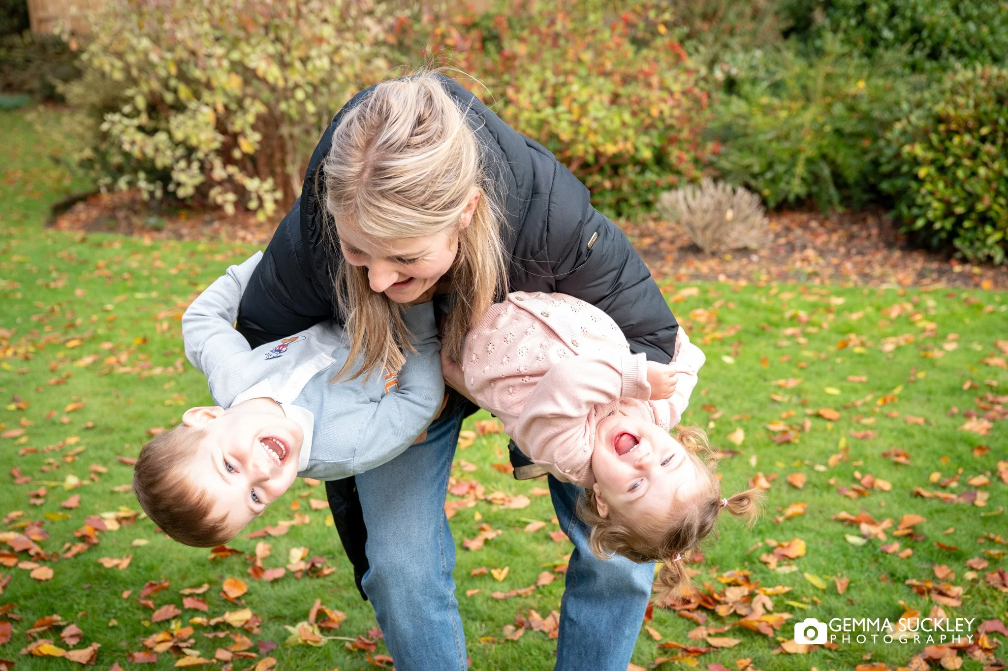 a mum tipping her kids upside down