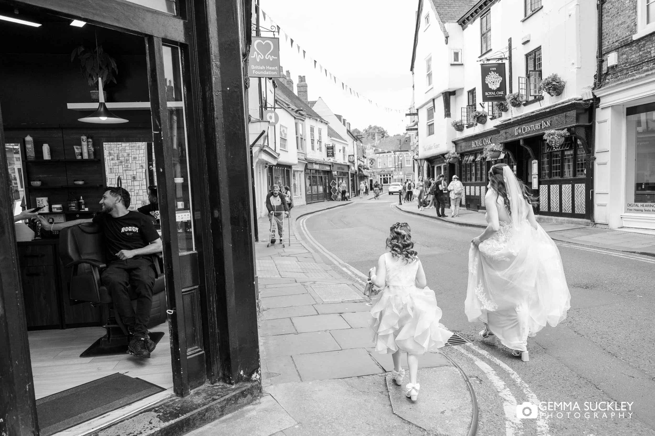 bride and bridesmaid walking through busy street in york