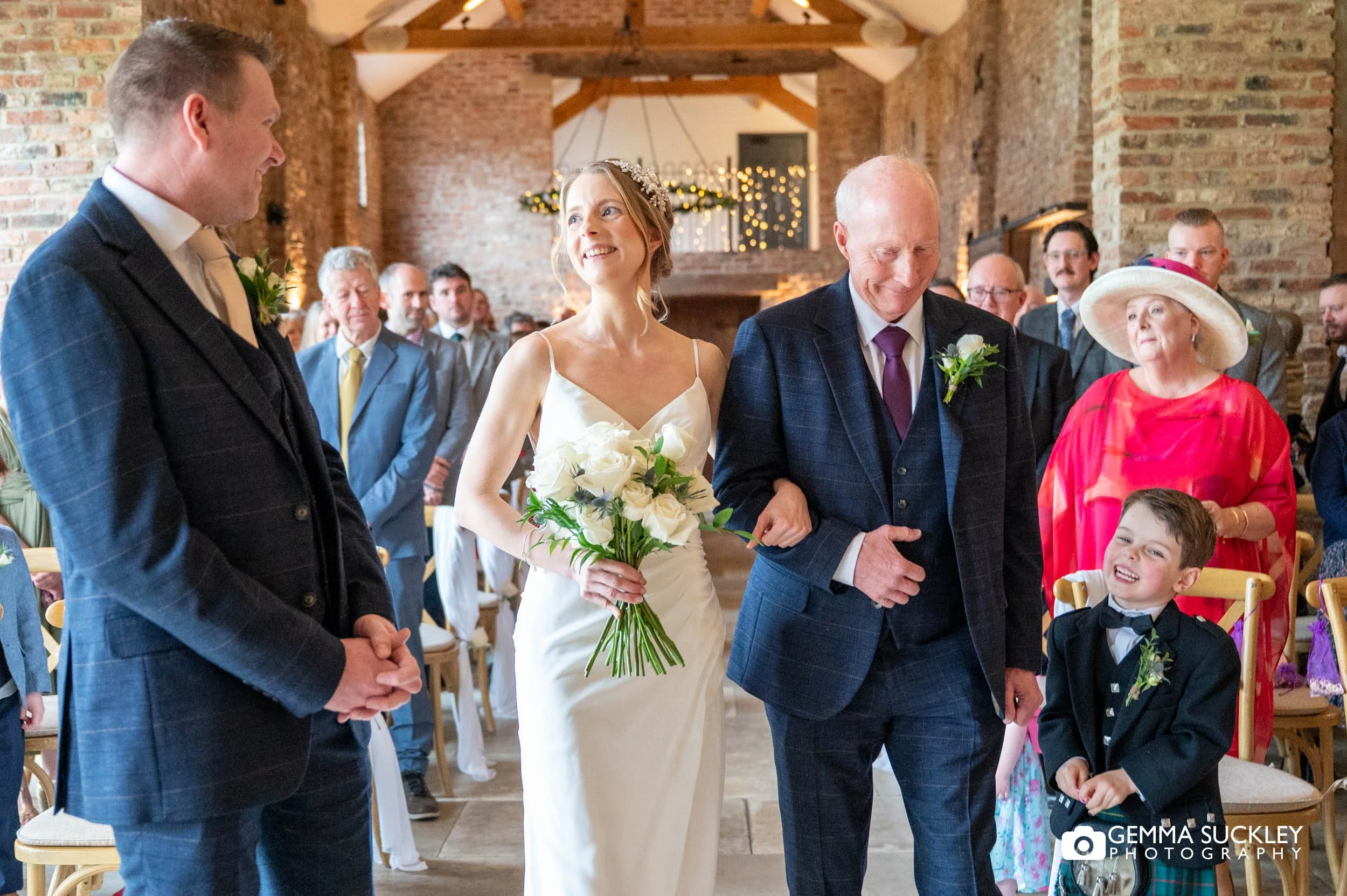 bride walk down the aisle at Thrisk Lodge Barns