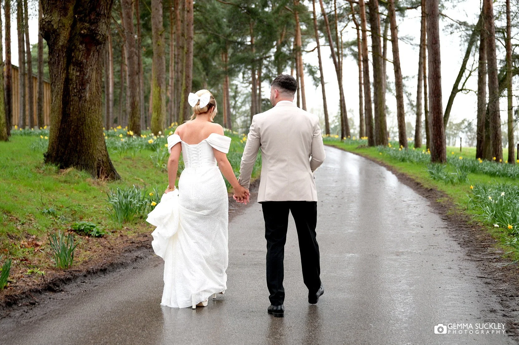 married couple walking up the road at the hovel wedding venue