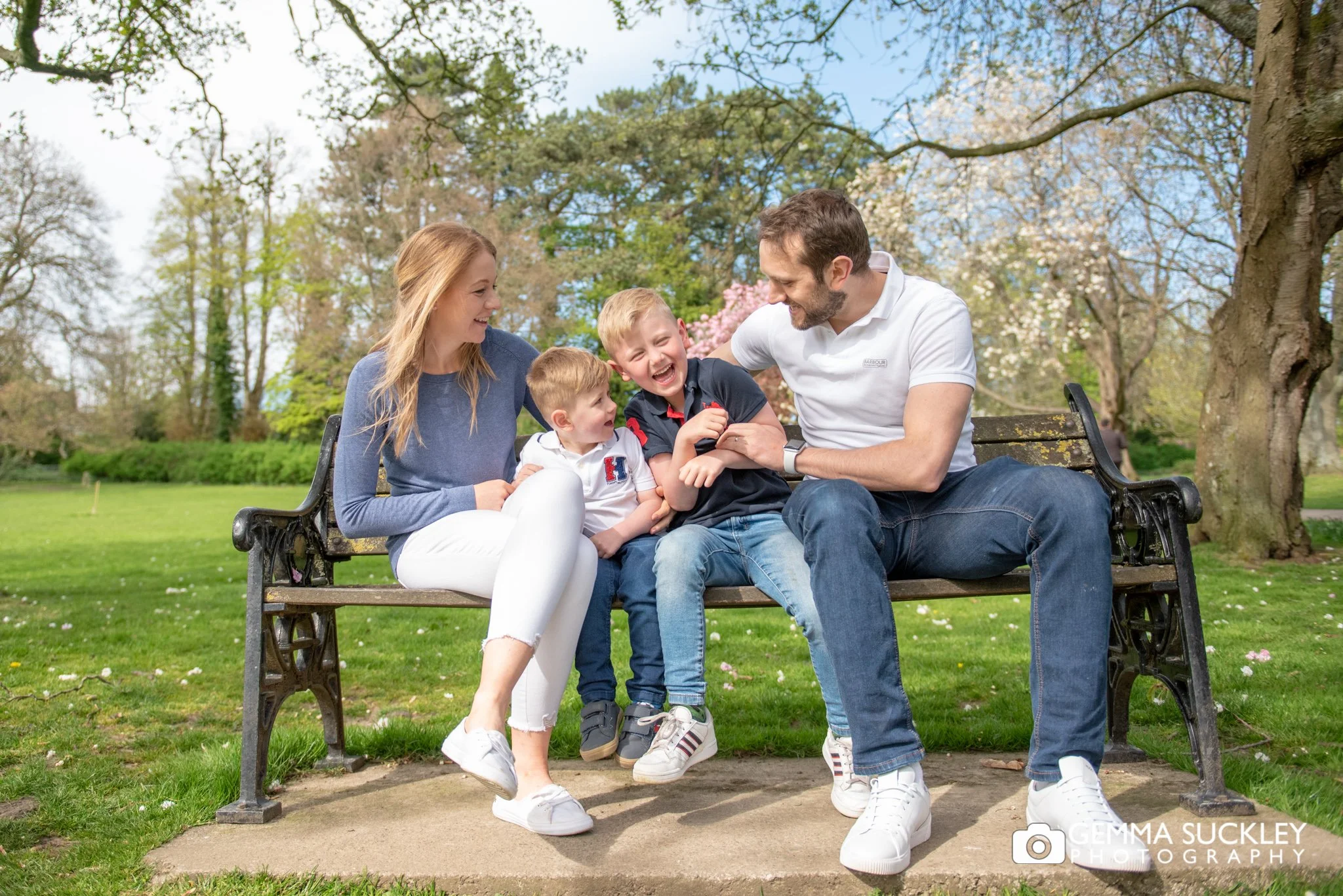 family giggling on a bench at aireville park