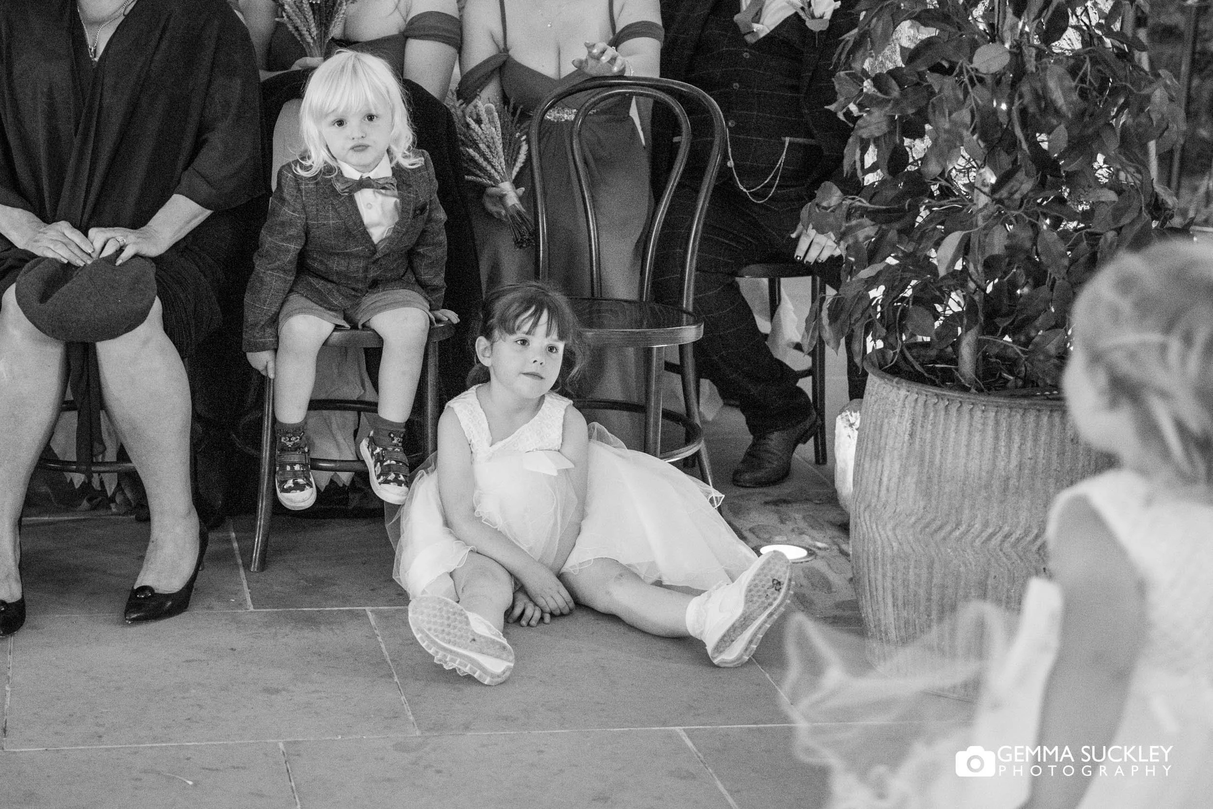kids sat on the floor at the tithe barn wedding ceremony