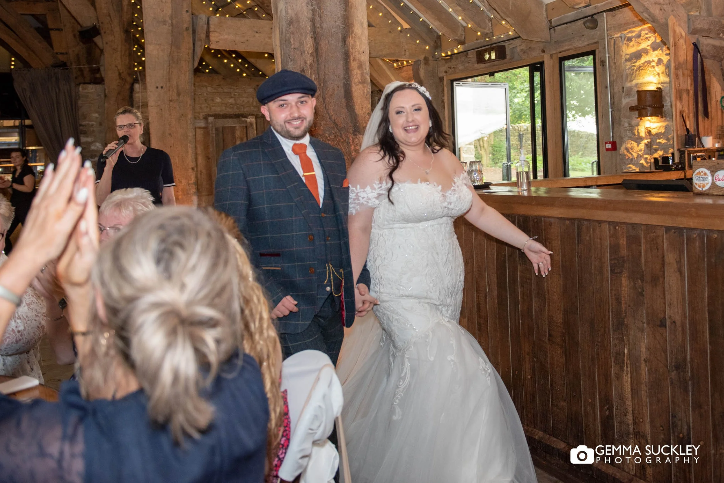 just married couple enter the tithe barn wedding