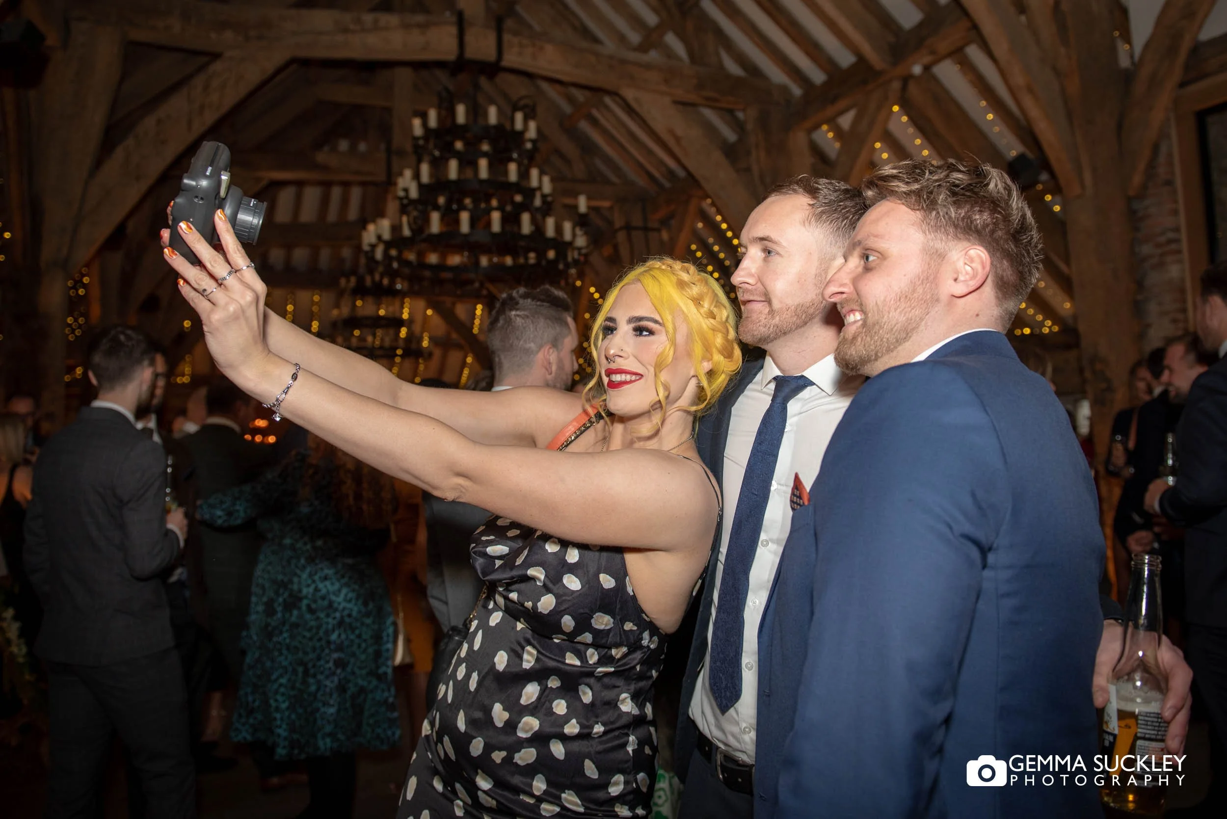 wedding guests taking a selfie in the tithe barn