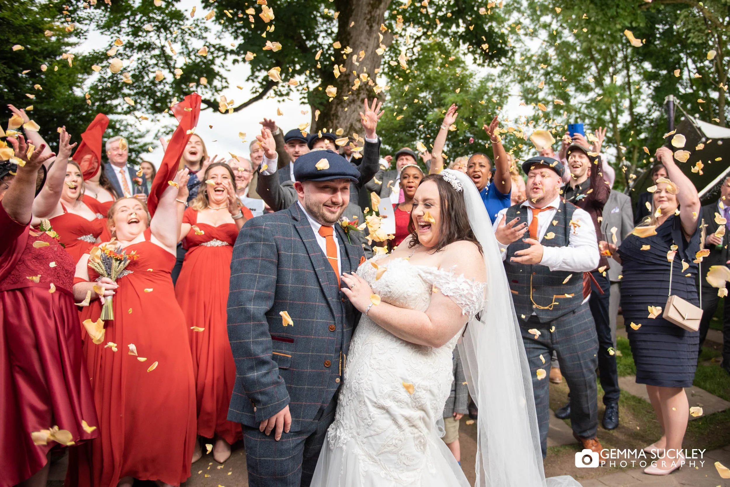 wedding guests throwing confetti at the tithe barn