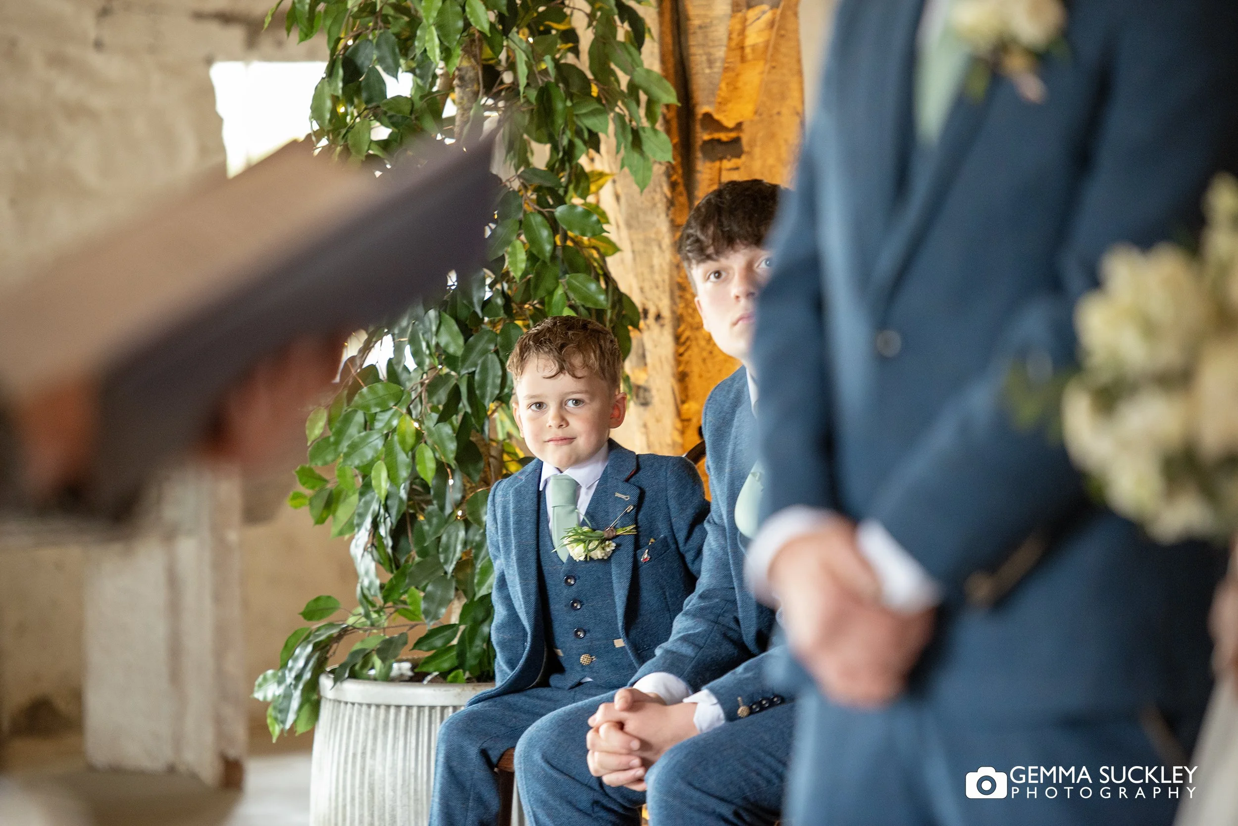 page boy watching his parents say their vows