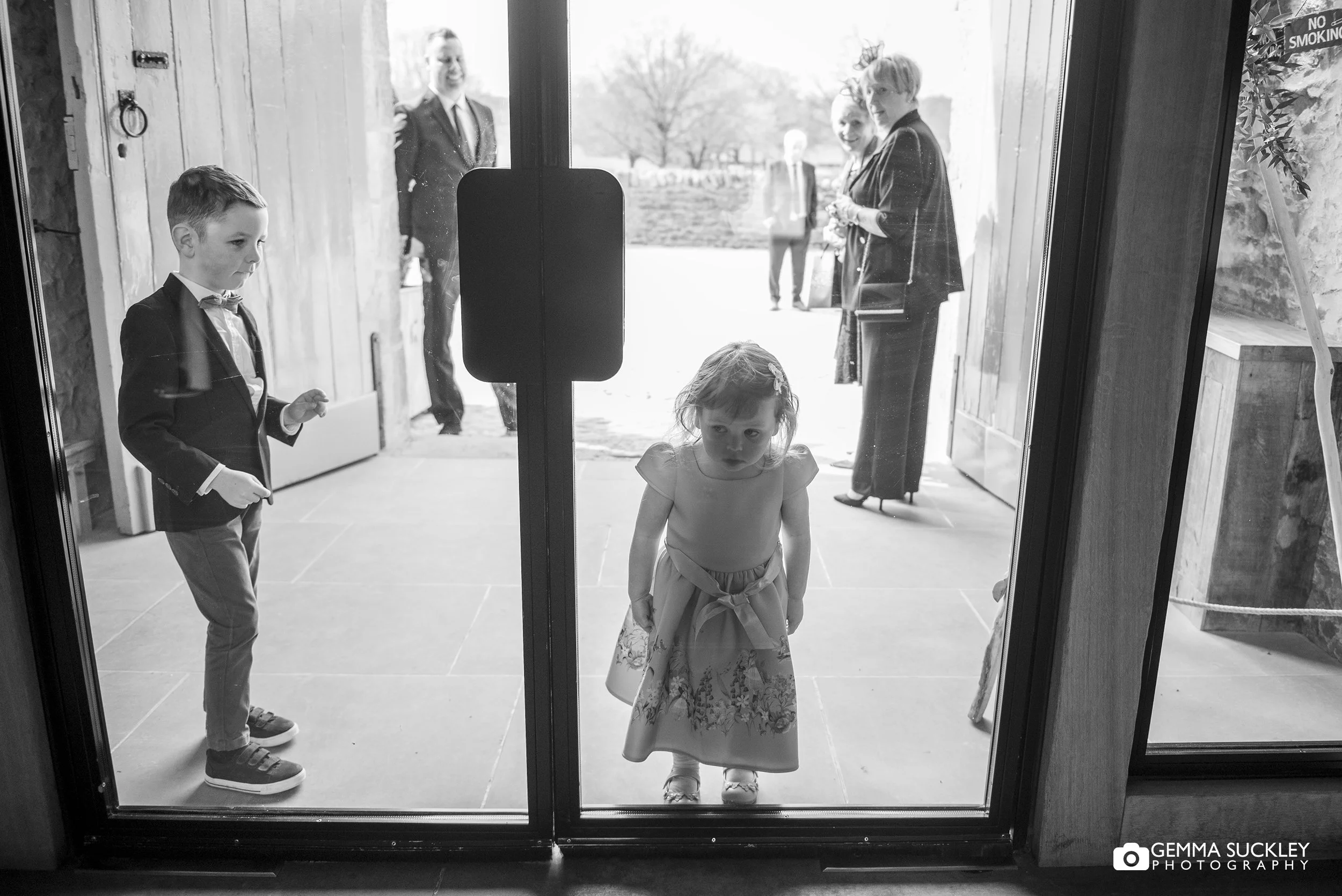 little girl looking in the windows at the tithe barn
