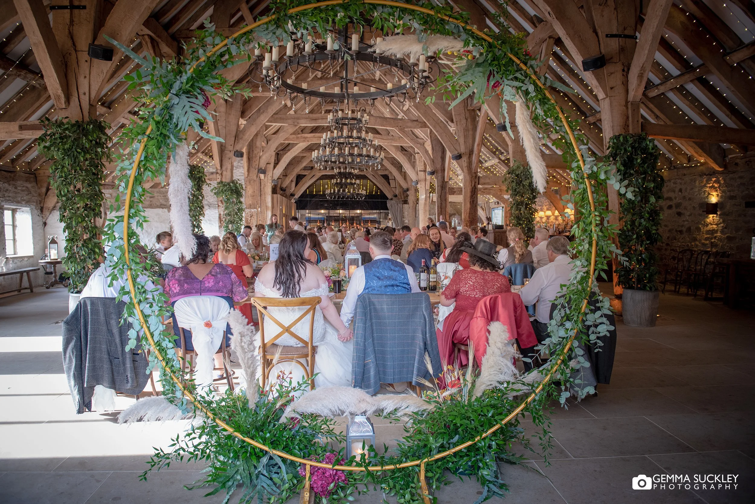 wedding party at tithe barn sitting for food 