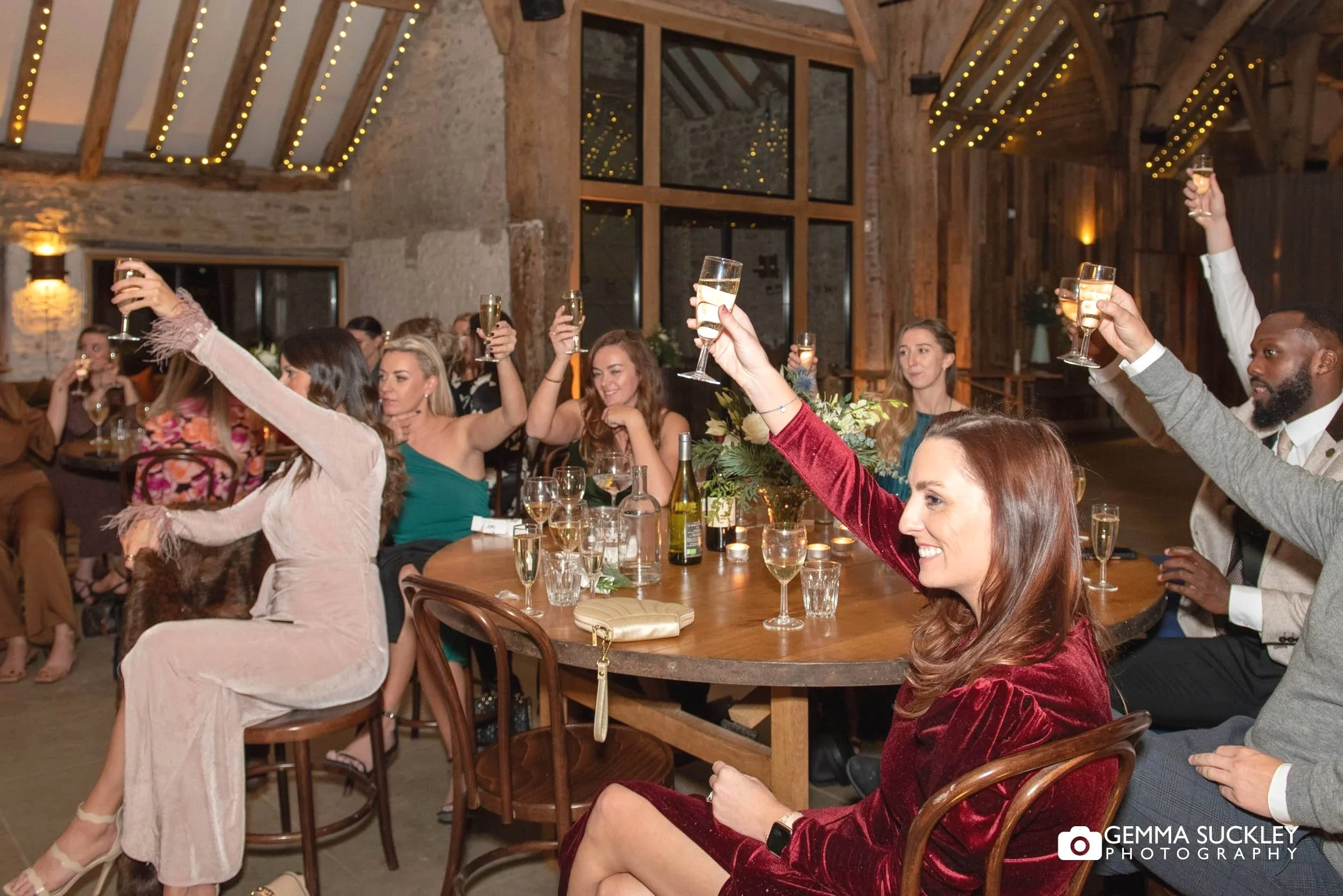 wedding guest toasting the couple at the tithe barn