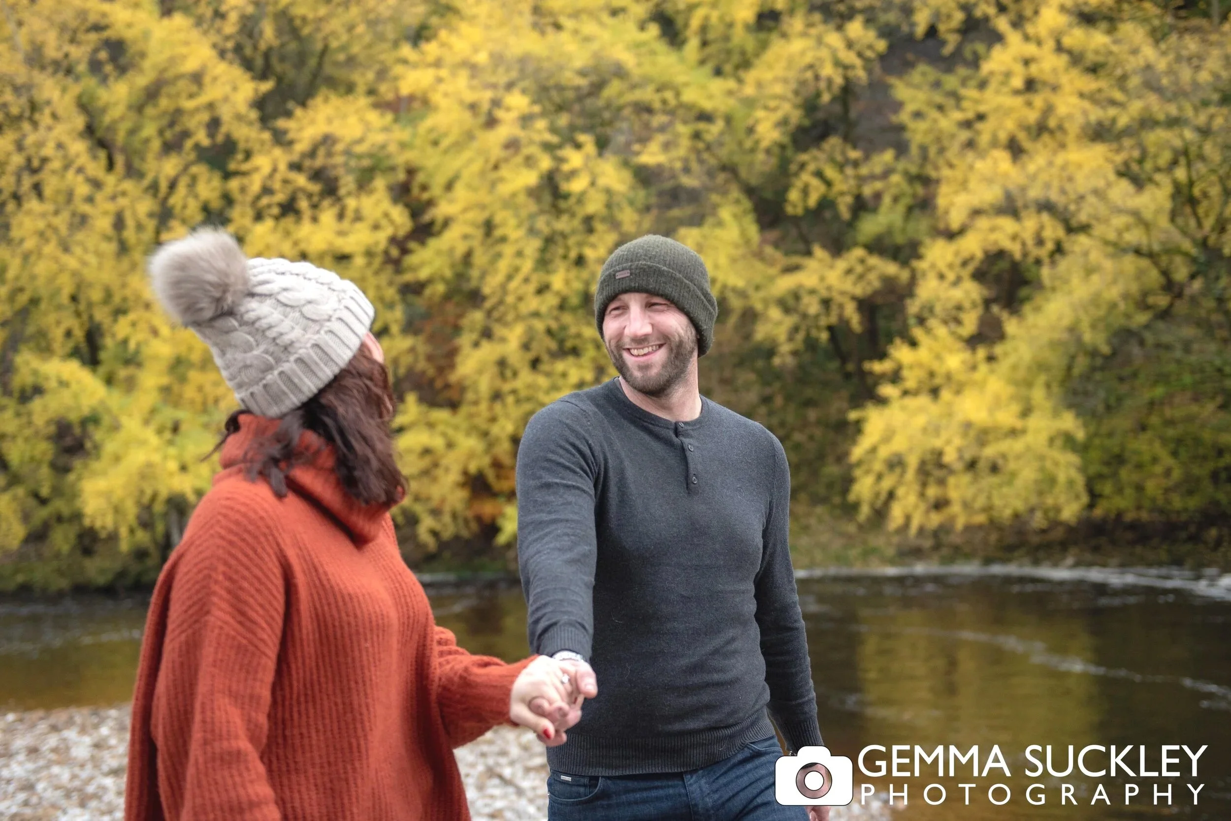 autumnal colourful photo at bolton abbey of an engaged couple