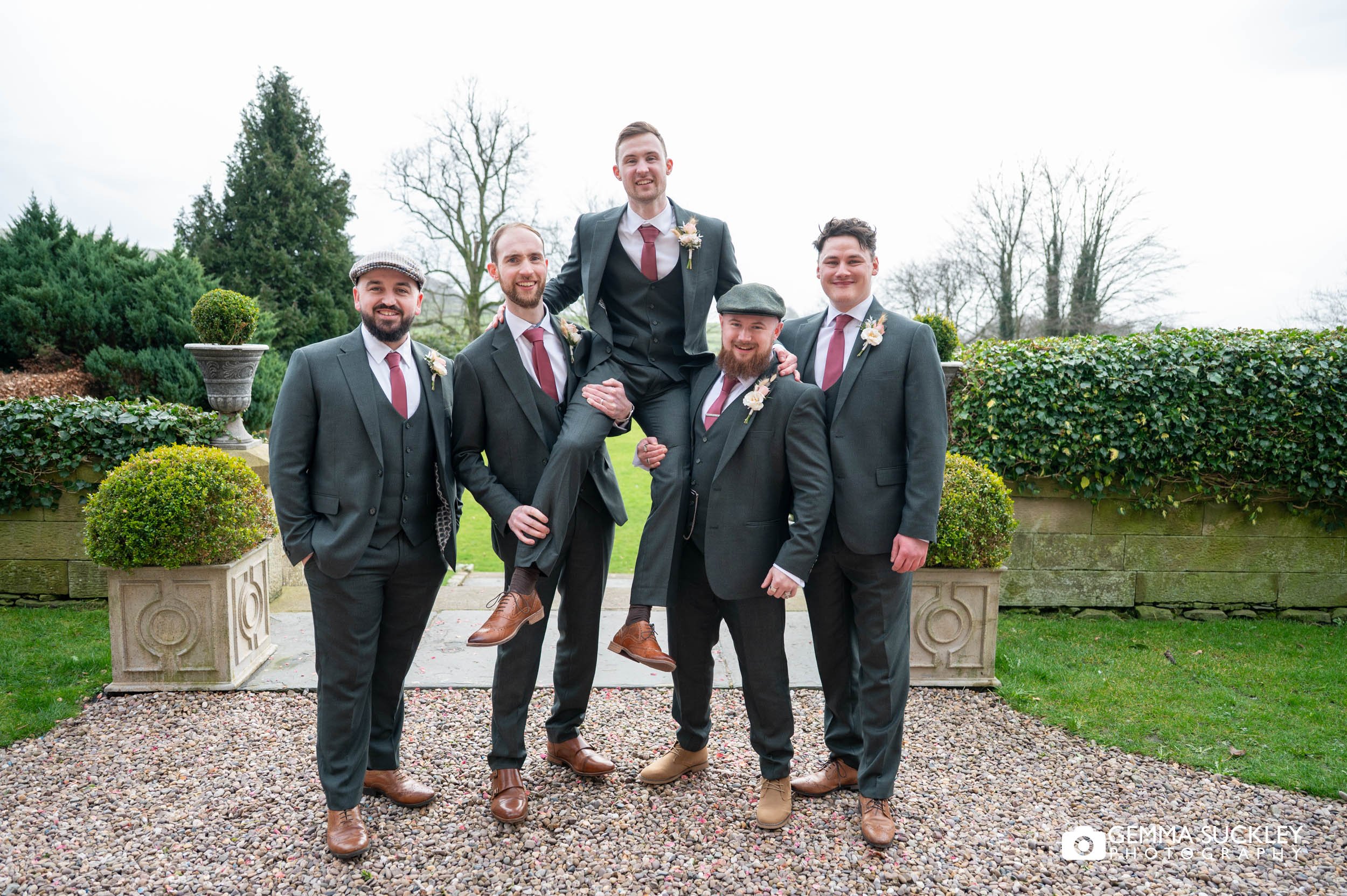 grooms party picking up the groom in the garden of falcon manor