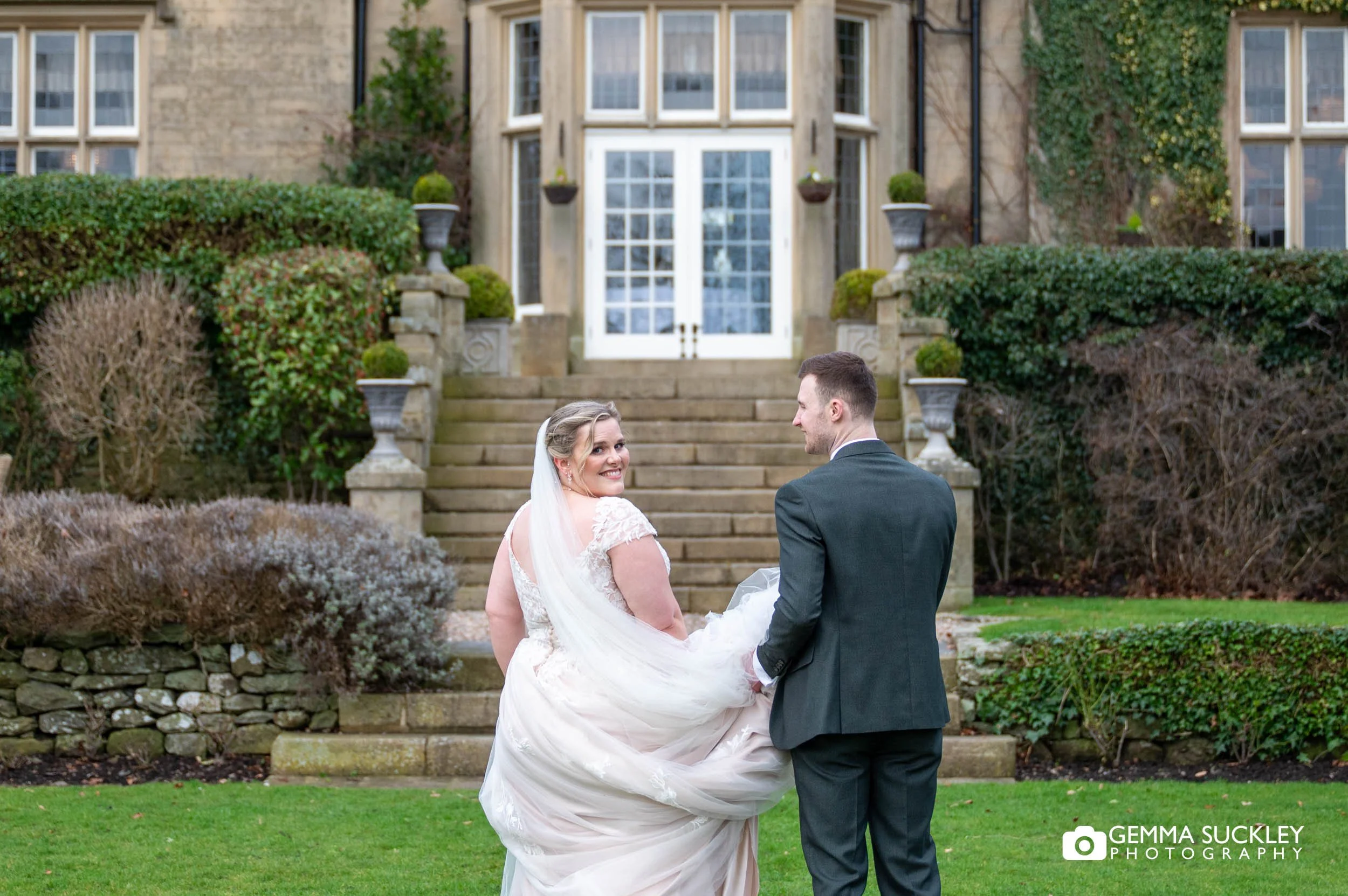 Newlyweds walking through the gardens at Falcon Manor in the Yorkshire Dales