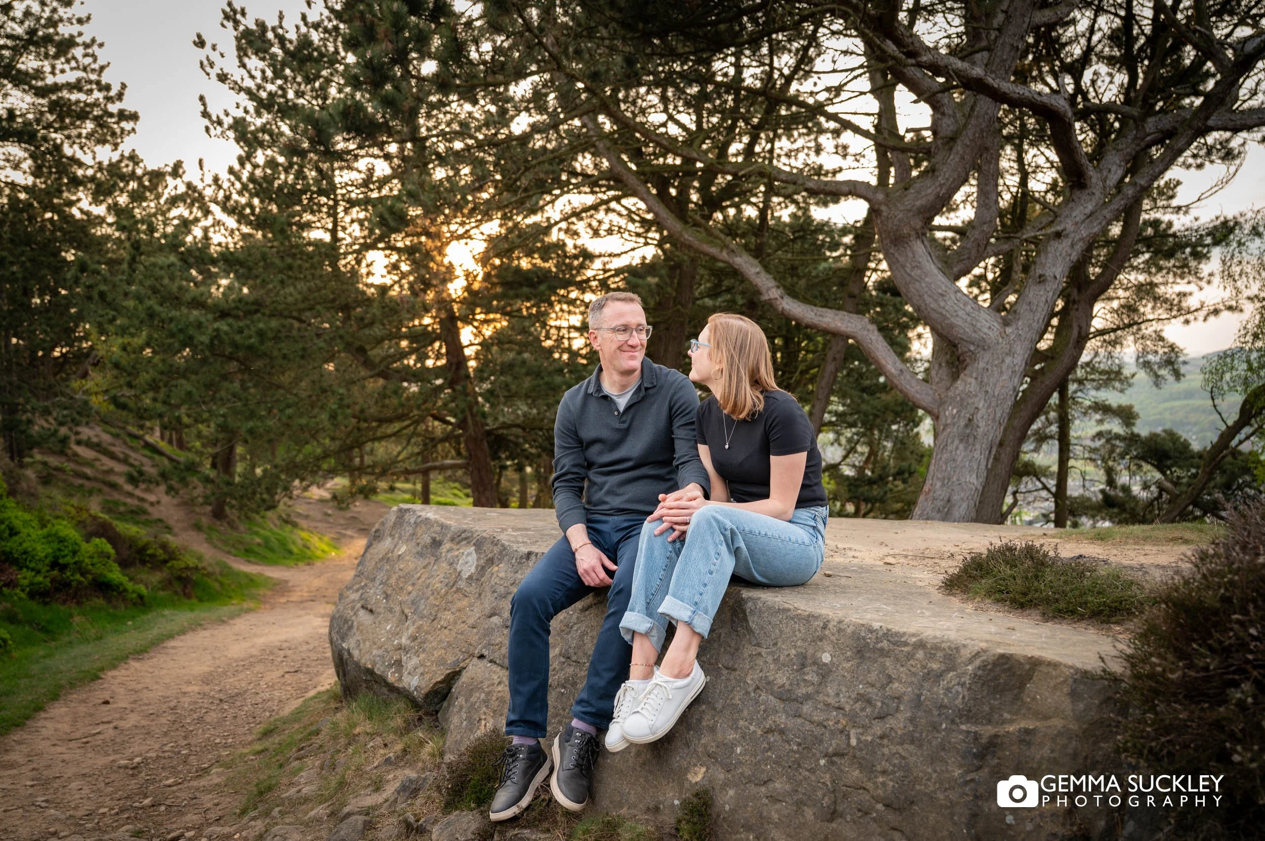 couple sitting together during their Ilkley Moor engagement shoot