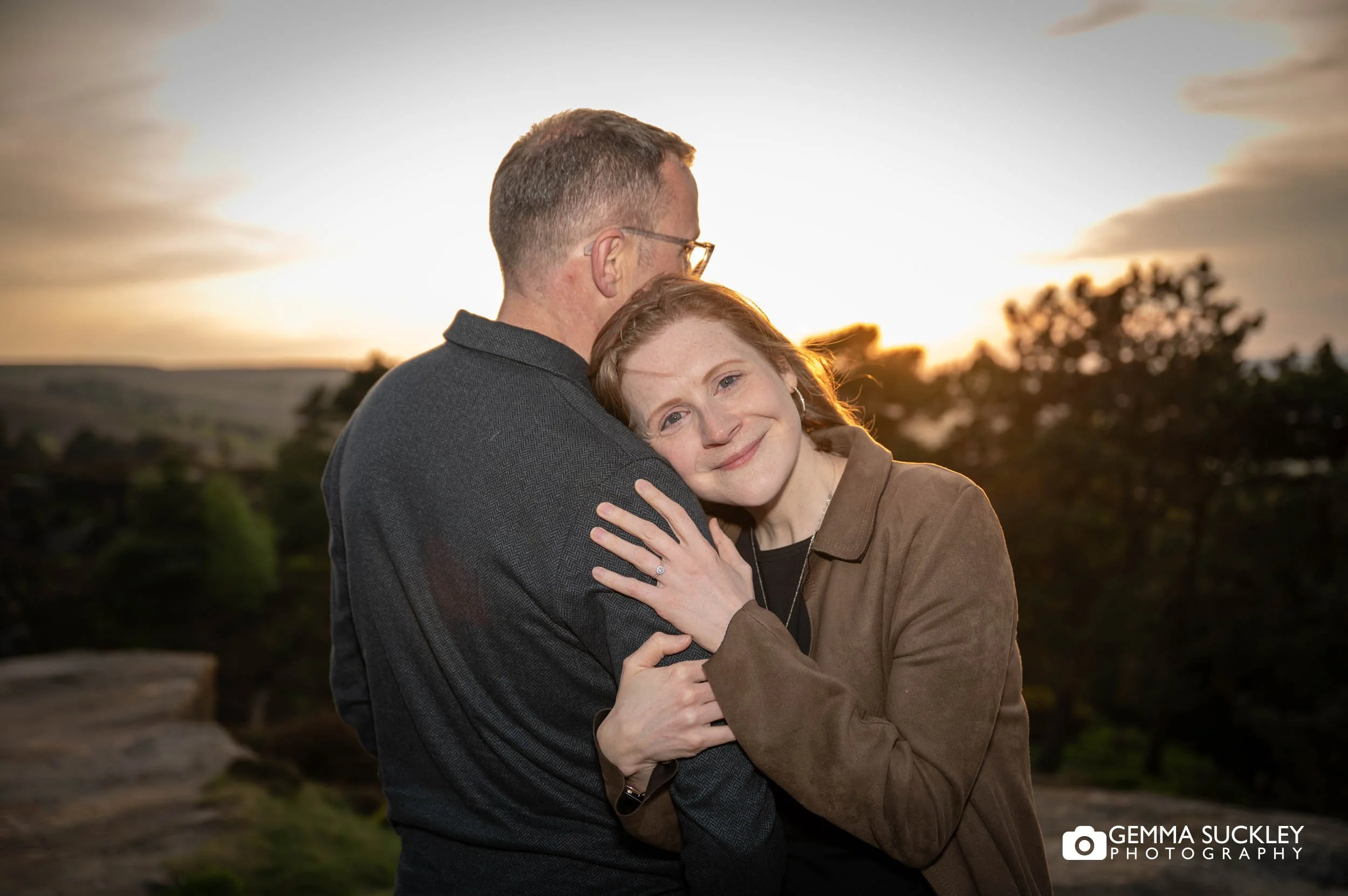 couple hugging at sunset on ilkley moor