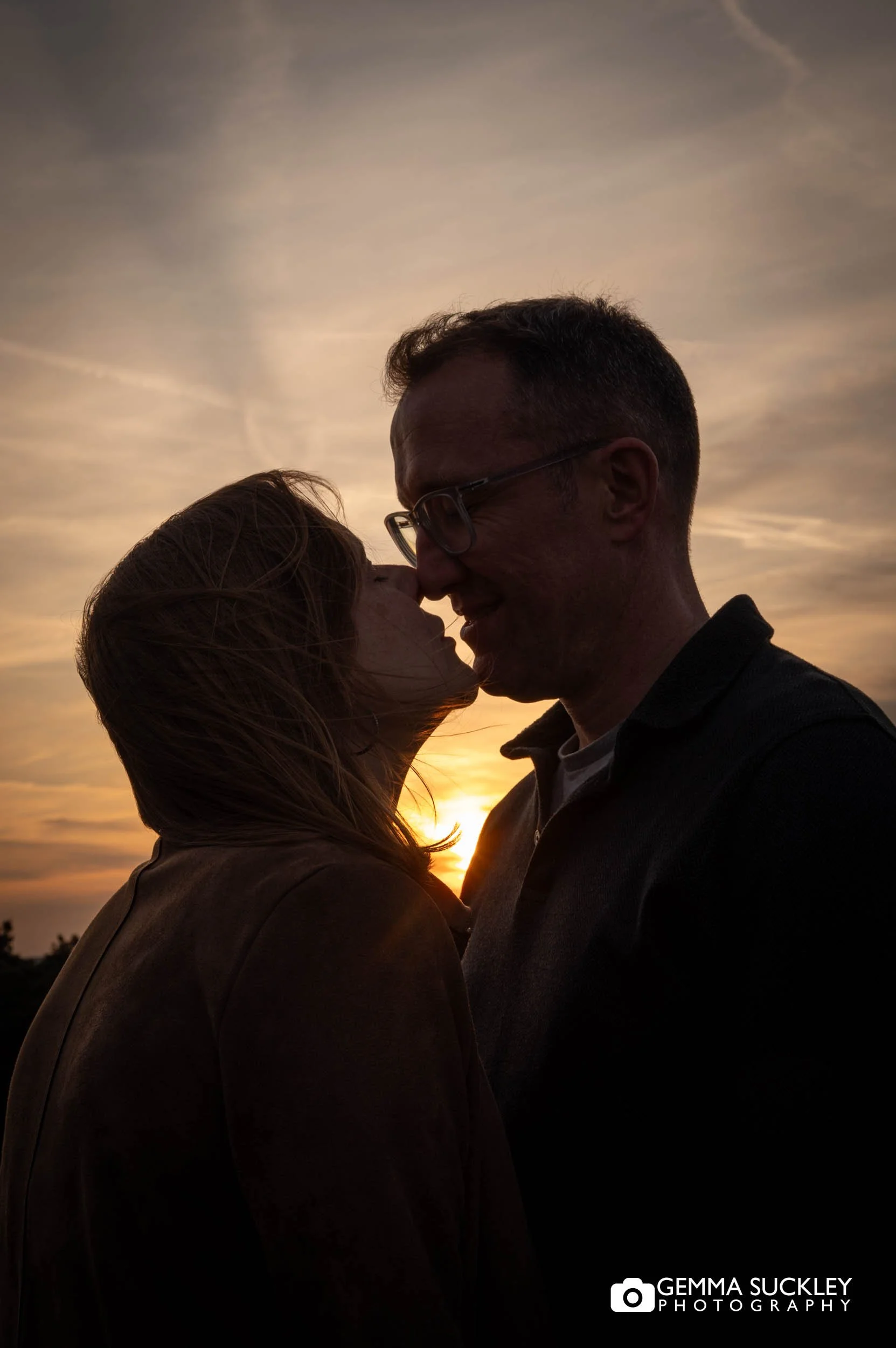 kissing couple on Ilkley Moor in Yorkshire at sunset