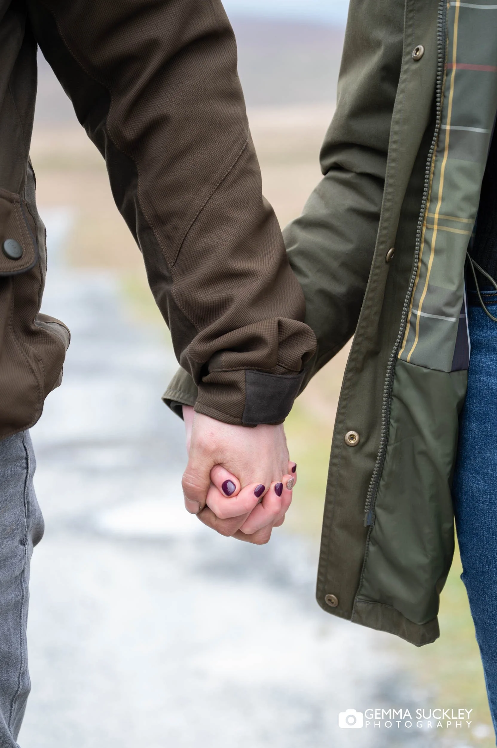 the hands of an engaged couple on their pre-wedding photoshoot