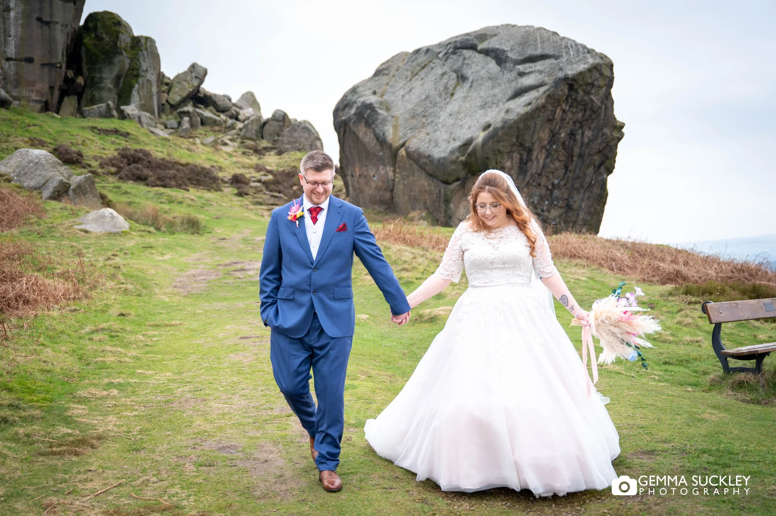 Bride and groom walking on Ilkley Moor after their wedding