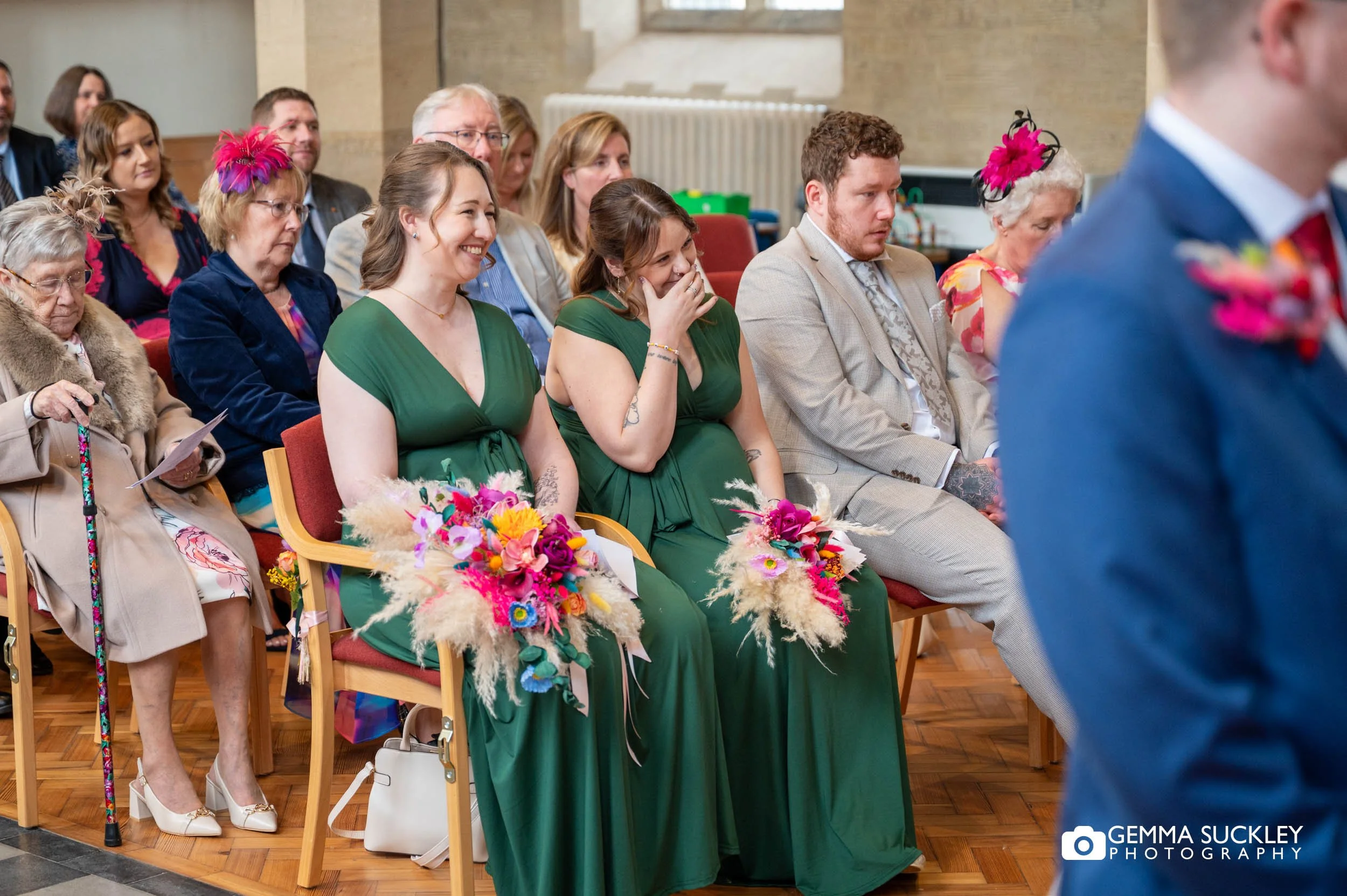 bridesmaids laughing in the wedding ceremony in ilkley church