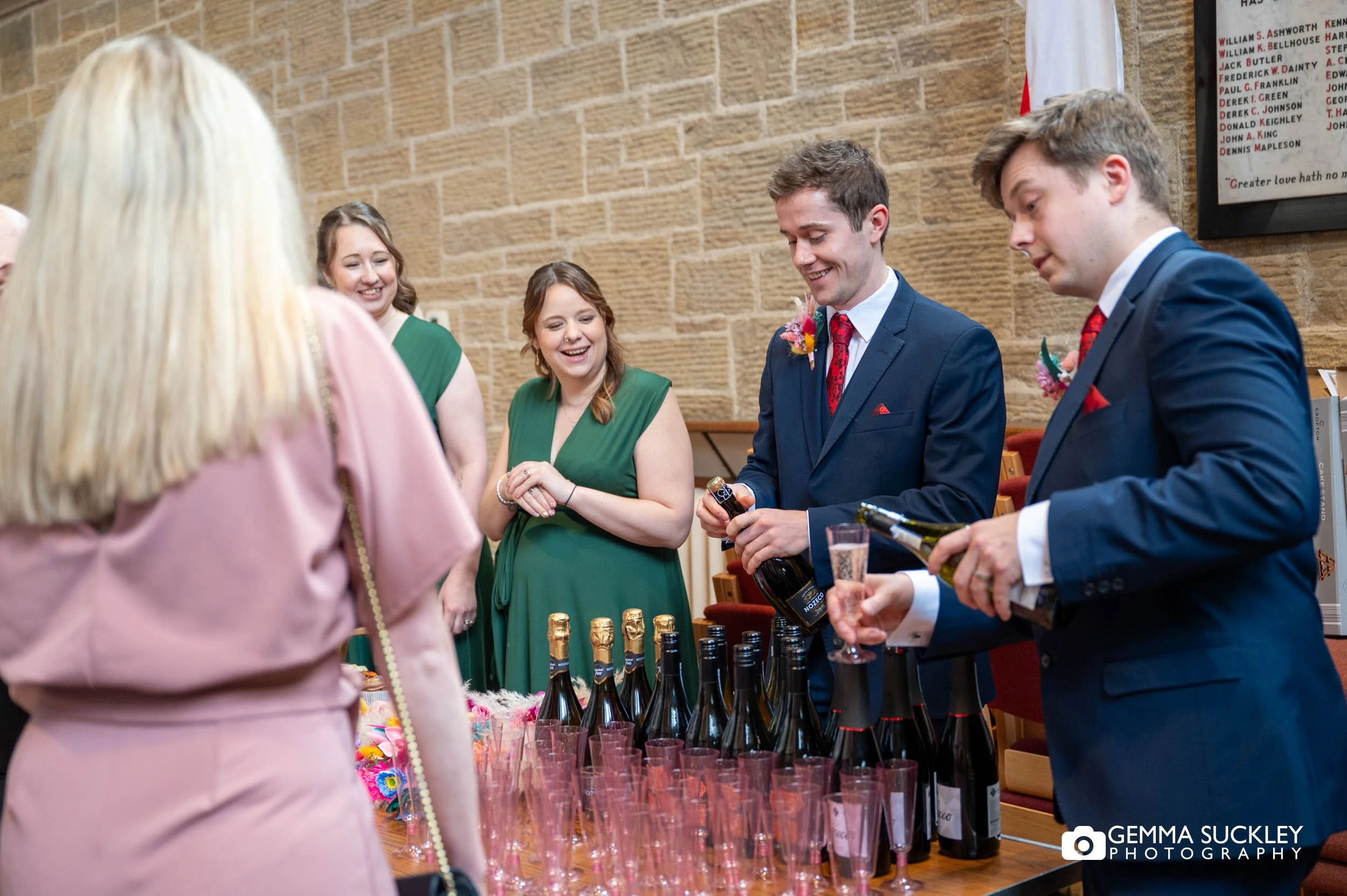 the grooms party serving drinks after the wedding ceremony