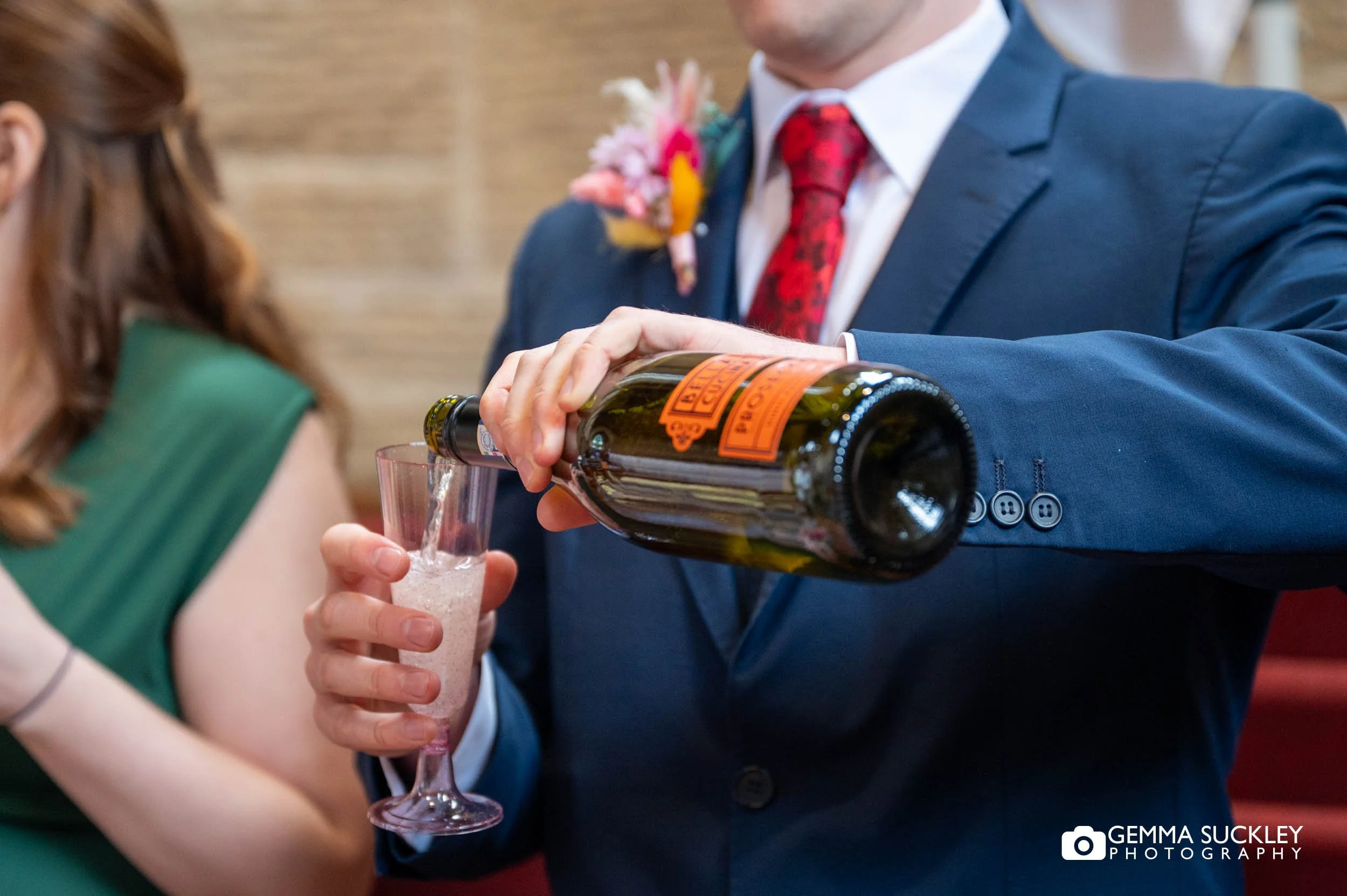 best man serving champagne after the wedding ceremony