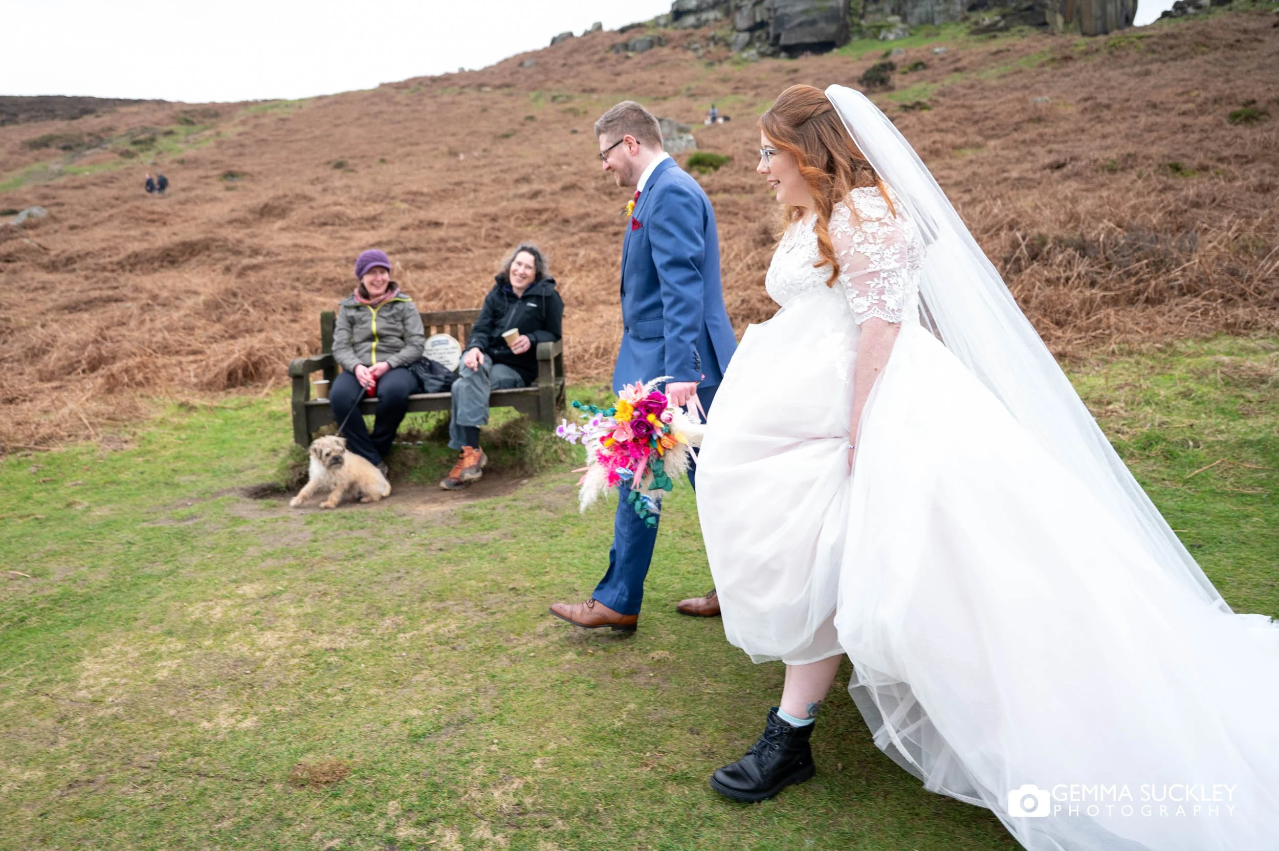 couple walking past ramblers on ilkley moor