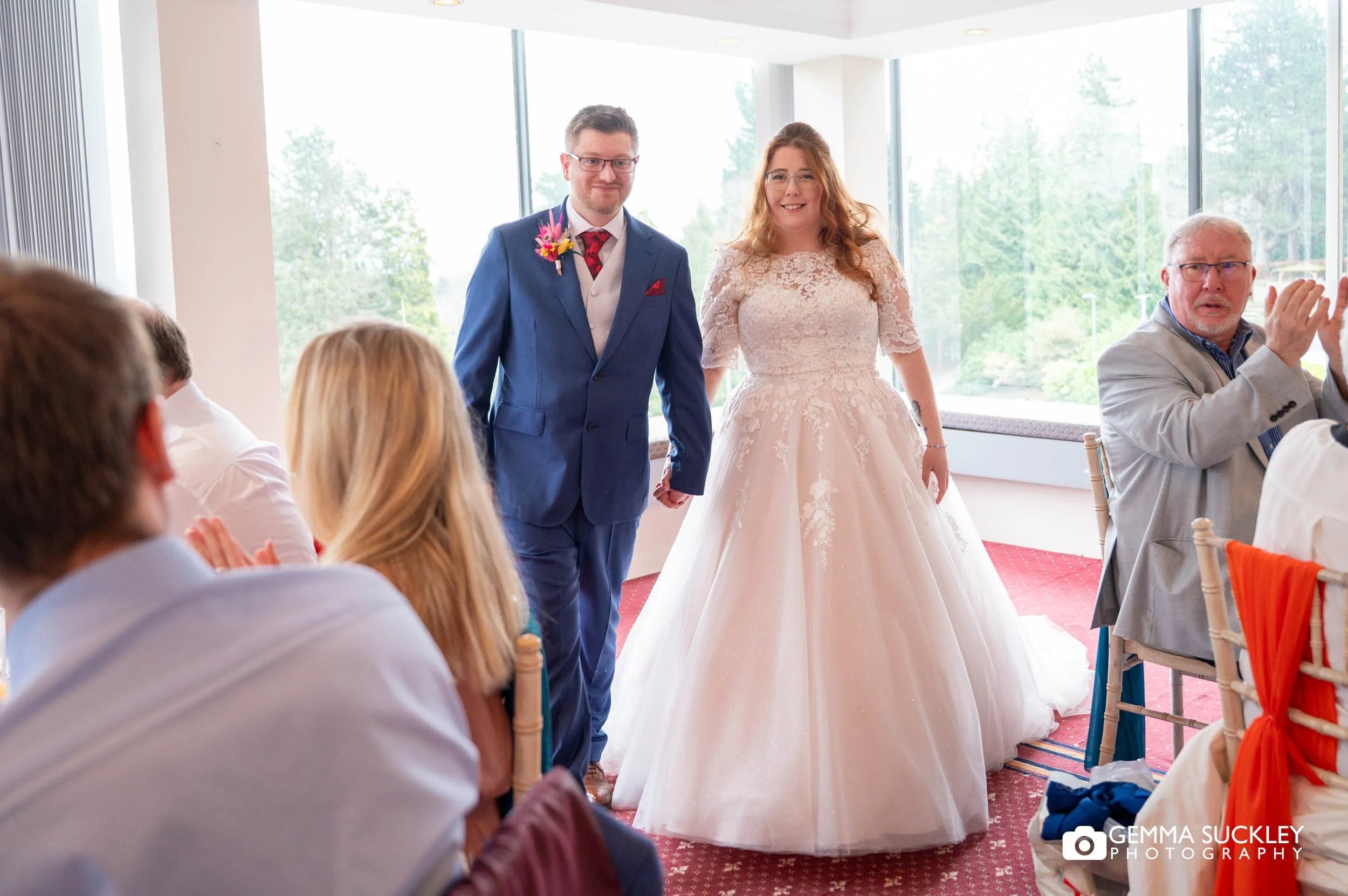 just married couple walking into the craiglands hotel to guests cheering