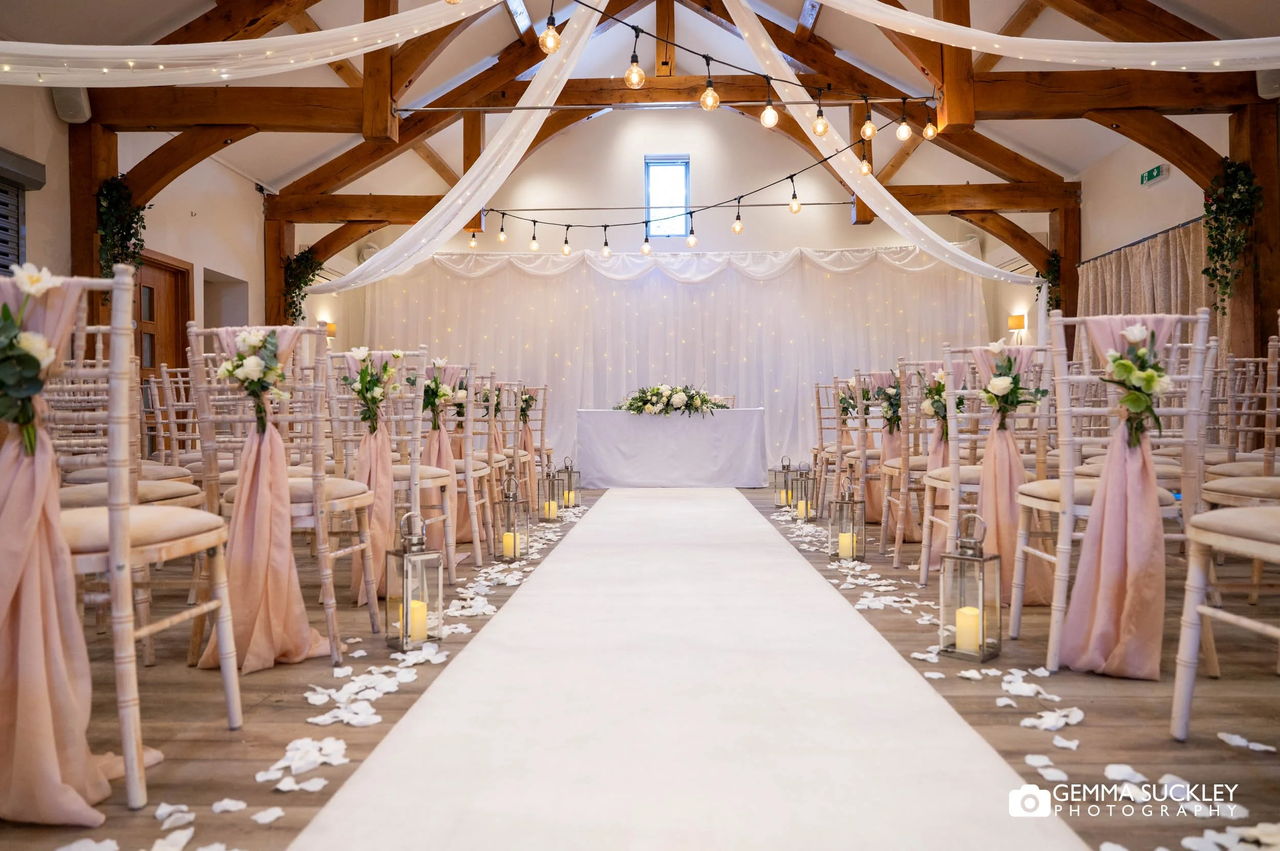 Rustic wedding ceremony room with fairy lights at The Gamekeeper’s Inn