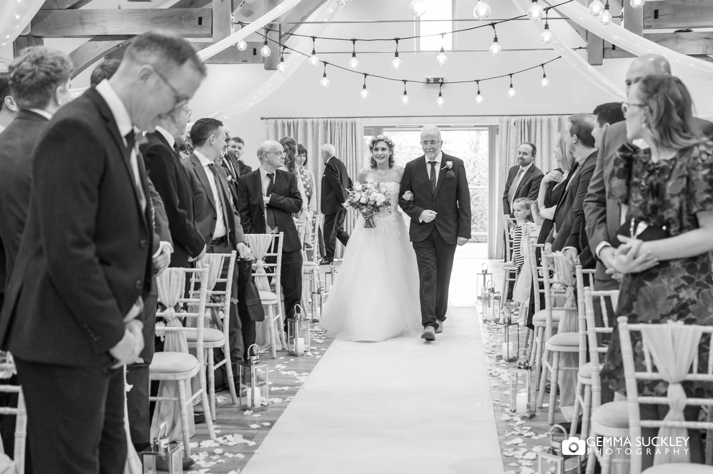 Bride walking down the aisle at The Gamekeeper’s Inn wedding ceremony