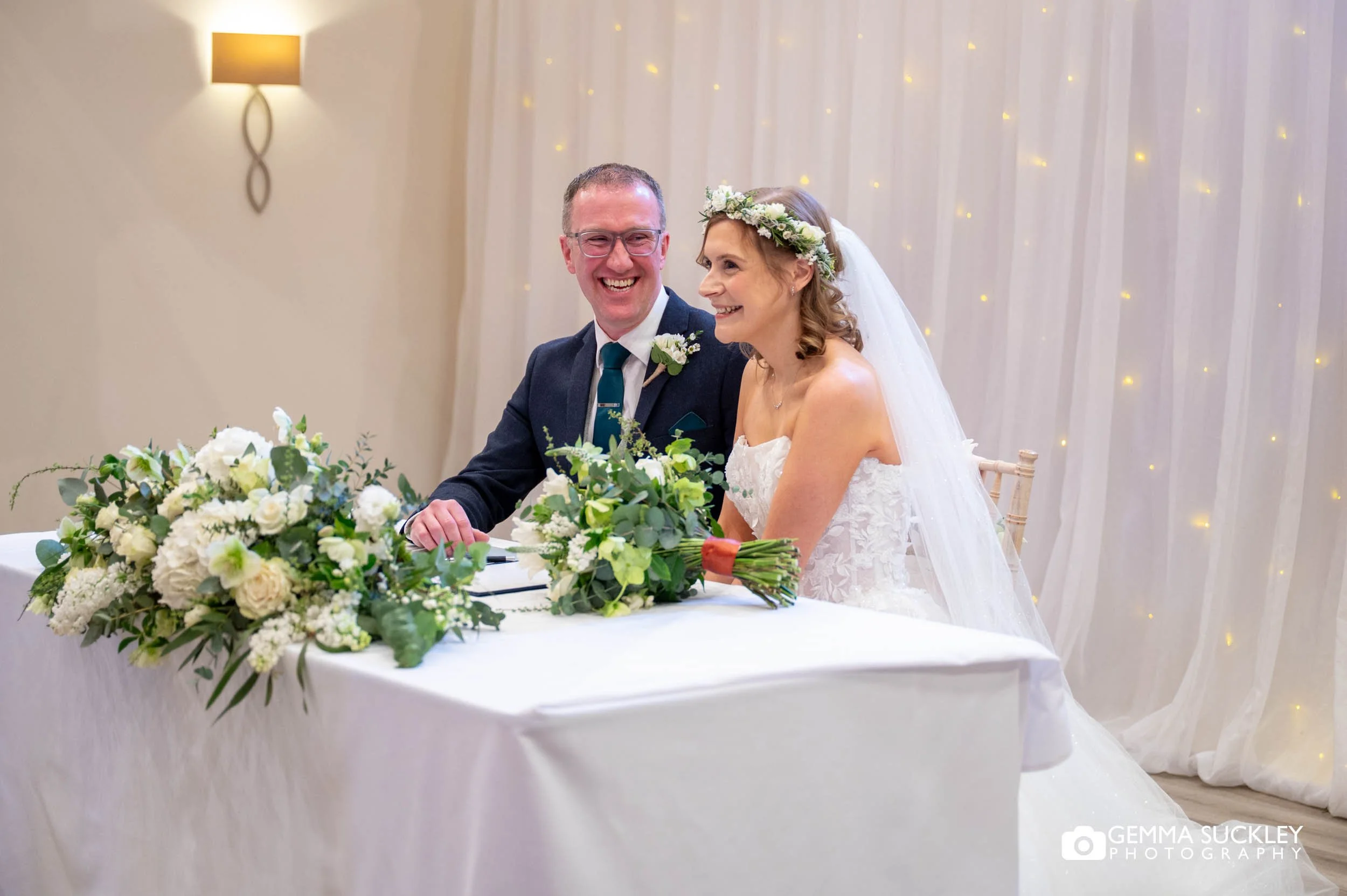 just married couple signing the register at the gamekeeper's inn