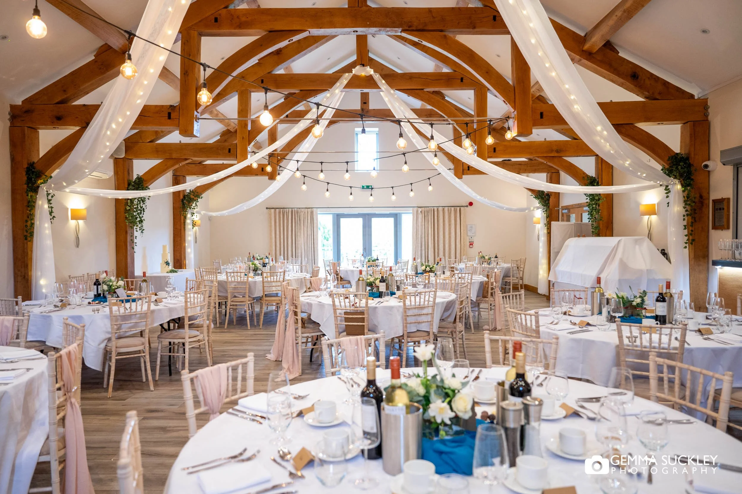 Rustic wedding reception with fairy lights at The Gamekeeper’s Inn