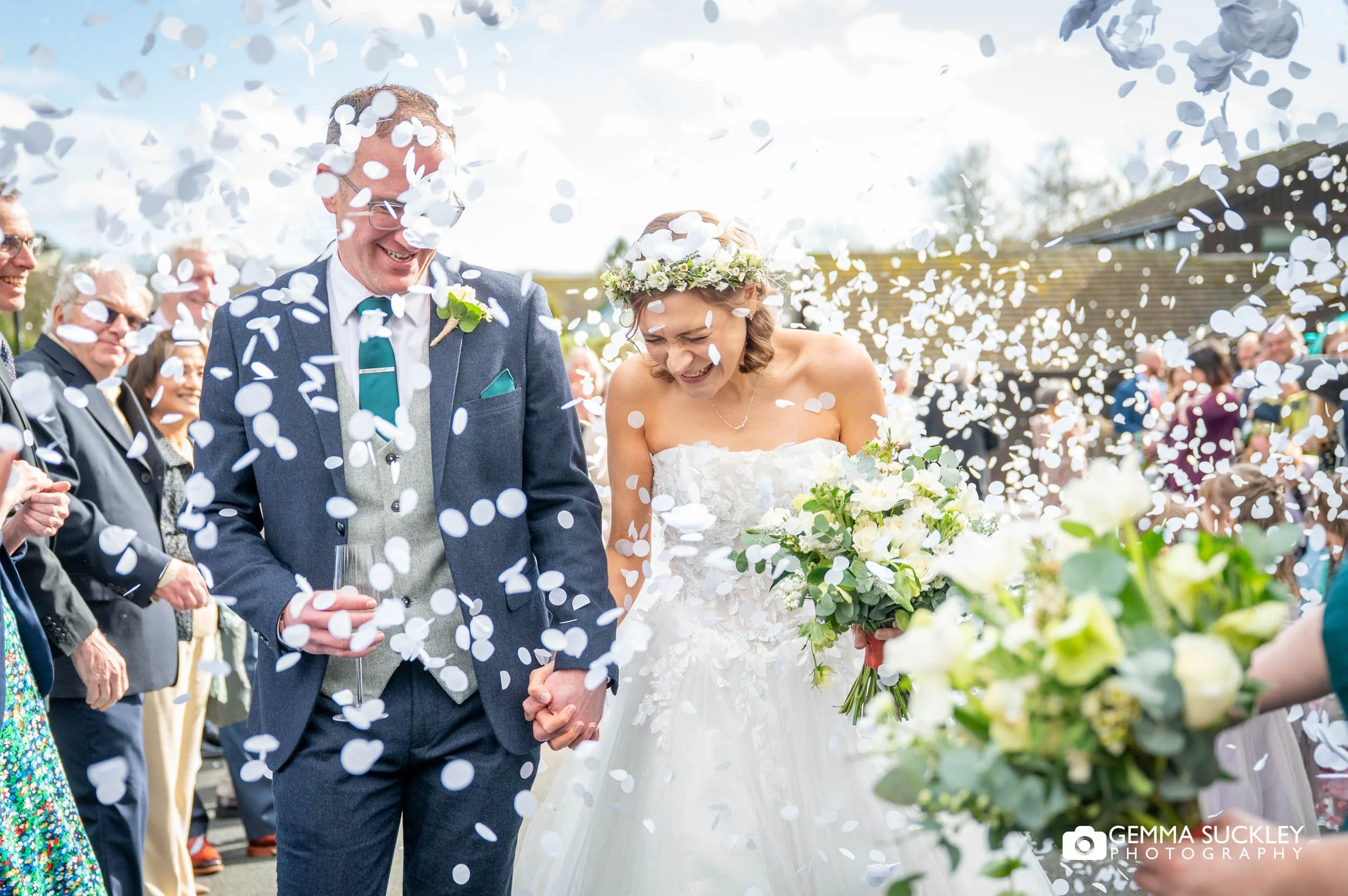 wedding guests throwing confetti at the gamekeeper's inn