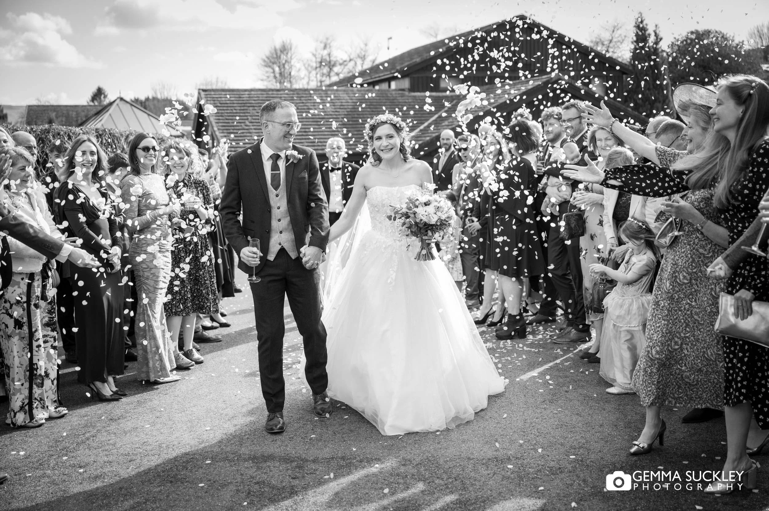 wedding guests throwing confetti outside the gamekeeper's inn