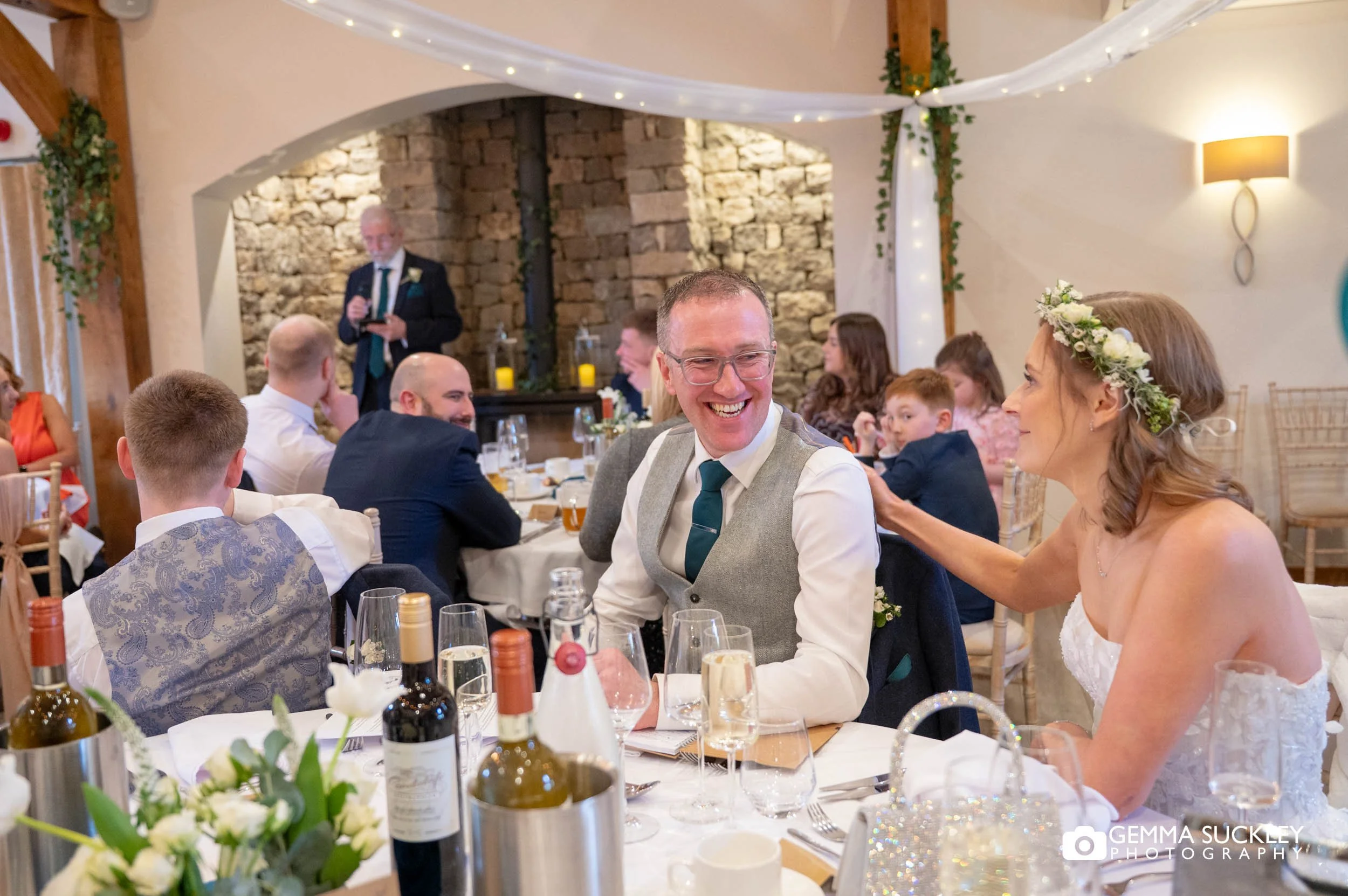 the couple reacting to speeches at the game keeper's inn wedding