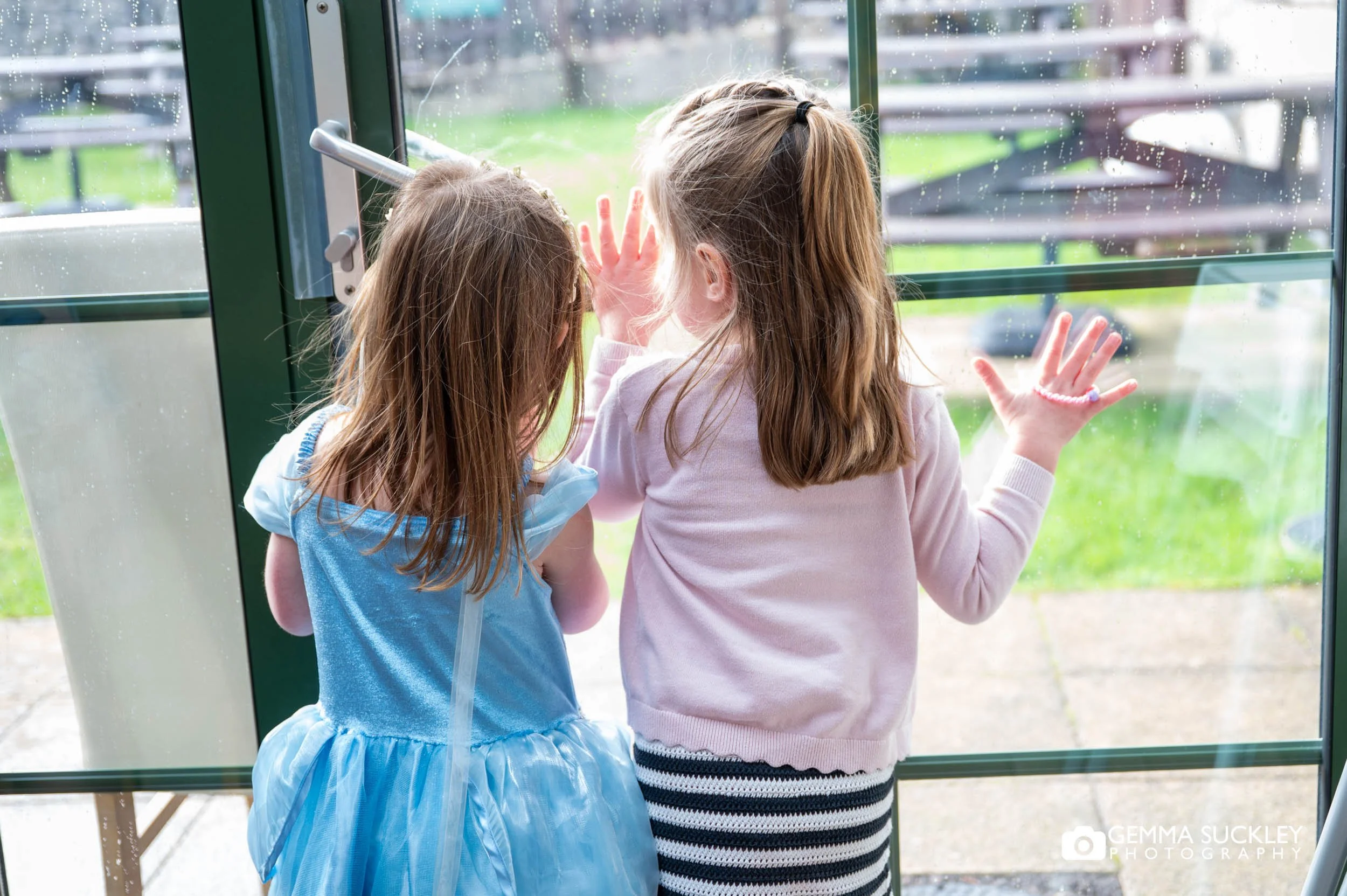 little girls looking out the window at the gamekeeper's inn wedding