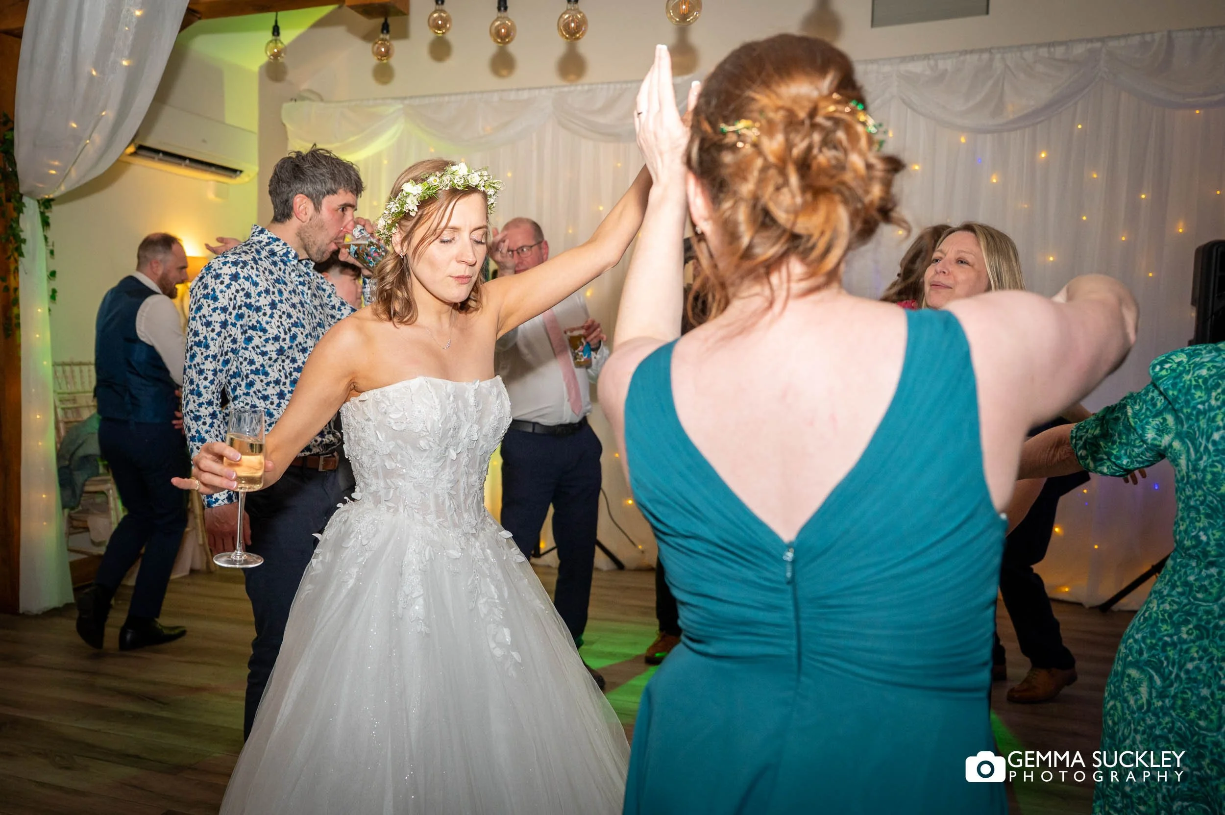 bride and bridesmaid dancing at the gamekeepers inn