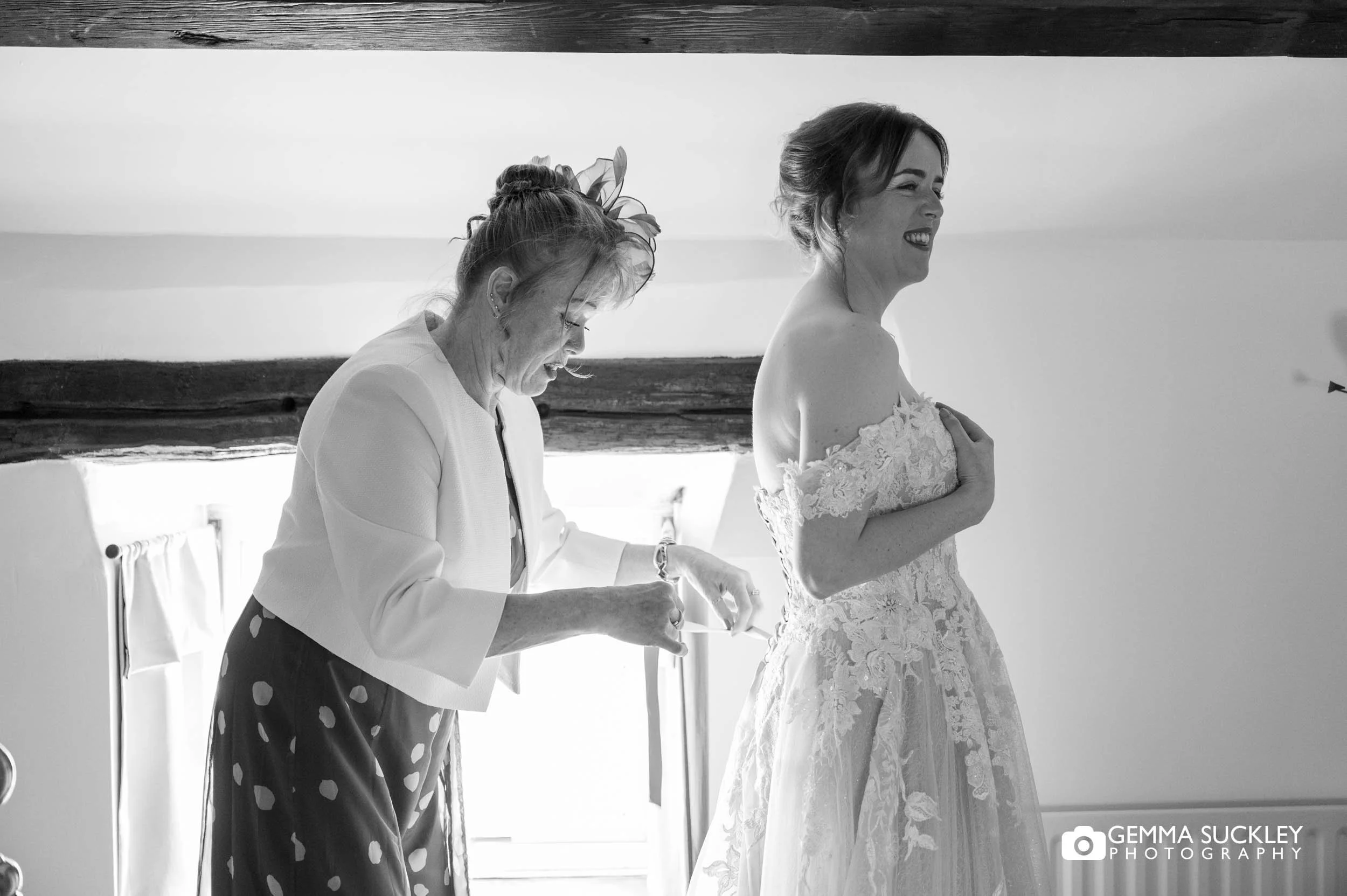 mother of the bride helping with the wedding dress at Falcon Manor