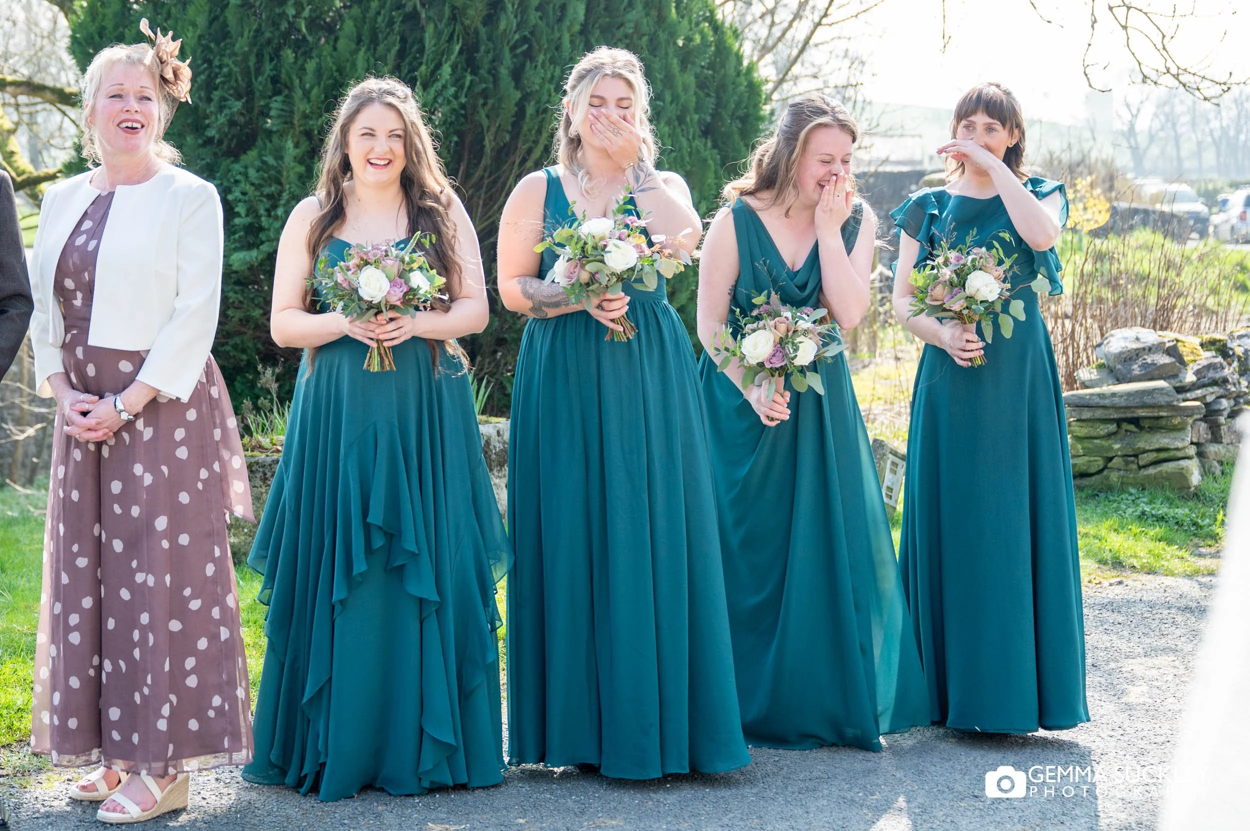 bridesmaids seeing the bride in her dress in settle
