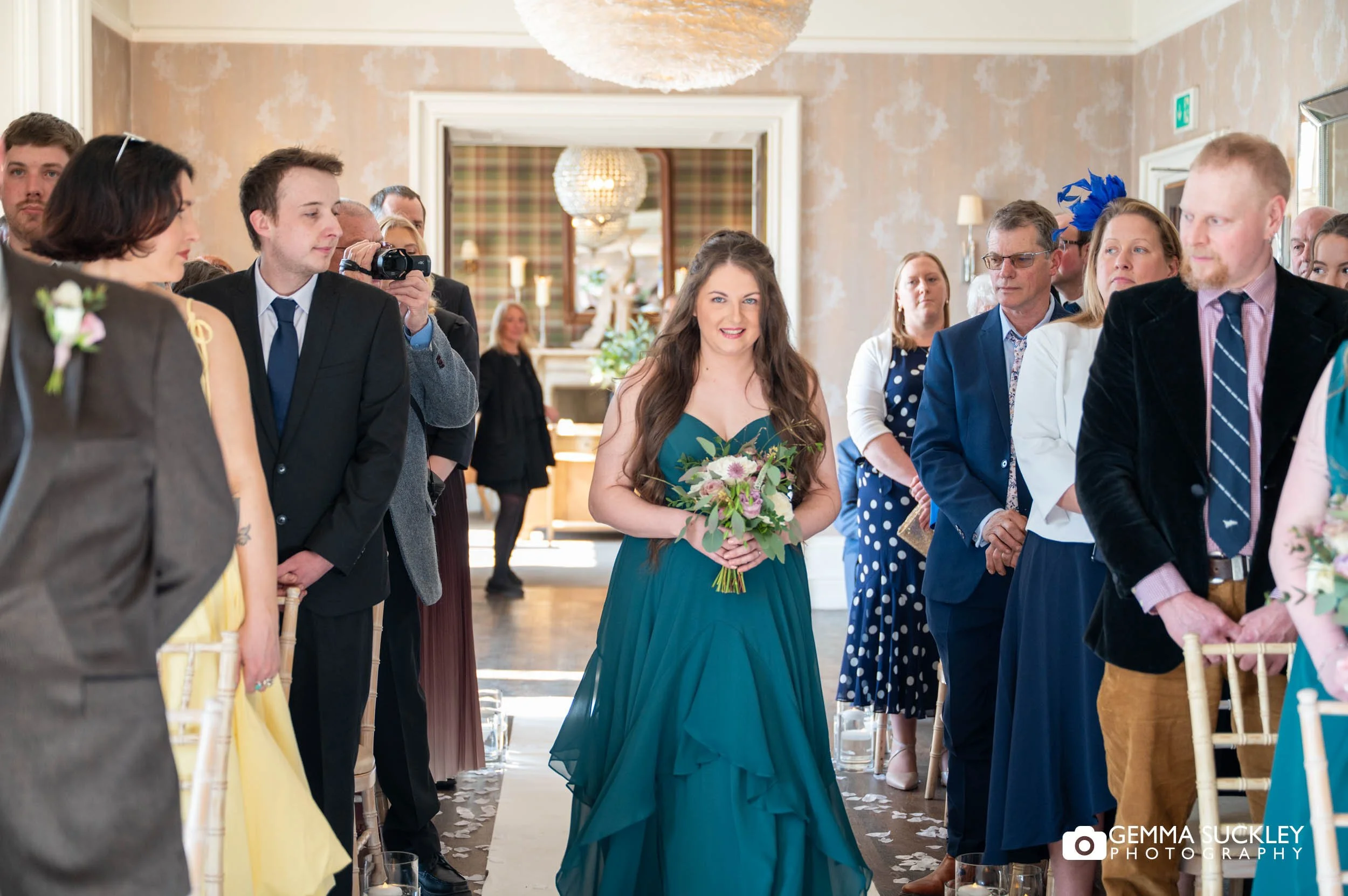 Bridesmaid walking down the aisle at Falcon Manor wedding ceremony
