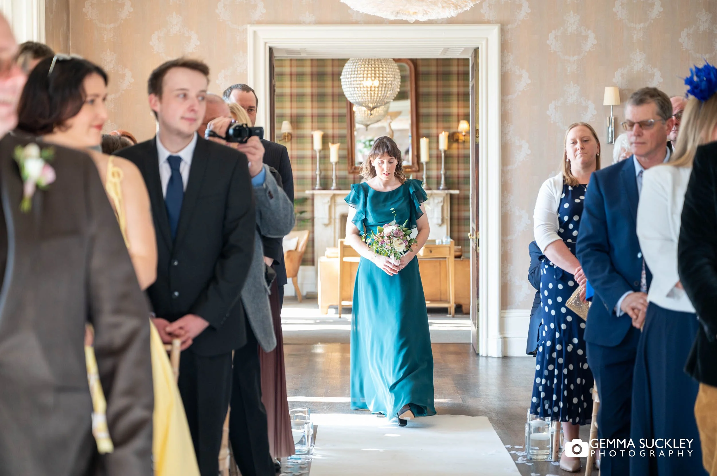 Bride walking down the aisle at Falcon Manor in settle