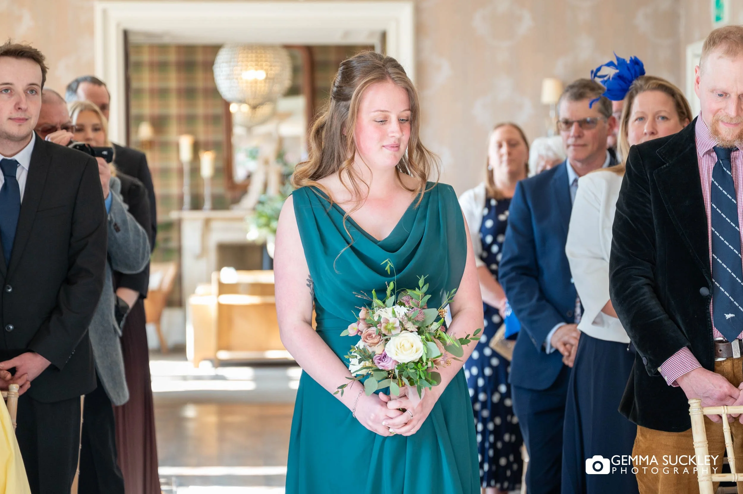 Bridesmaid walking down the aisle at Falcon Manor wedding