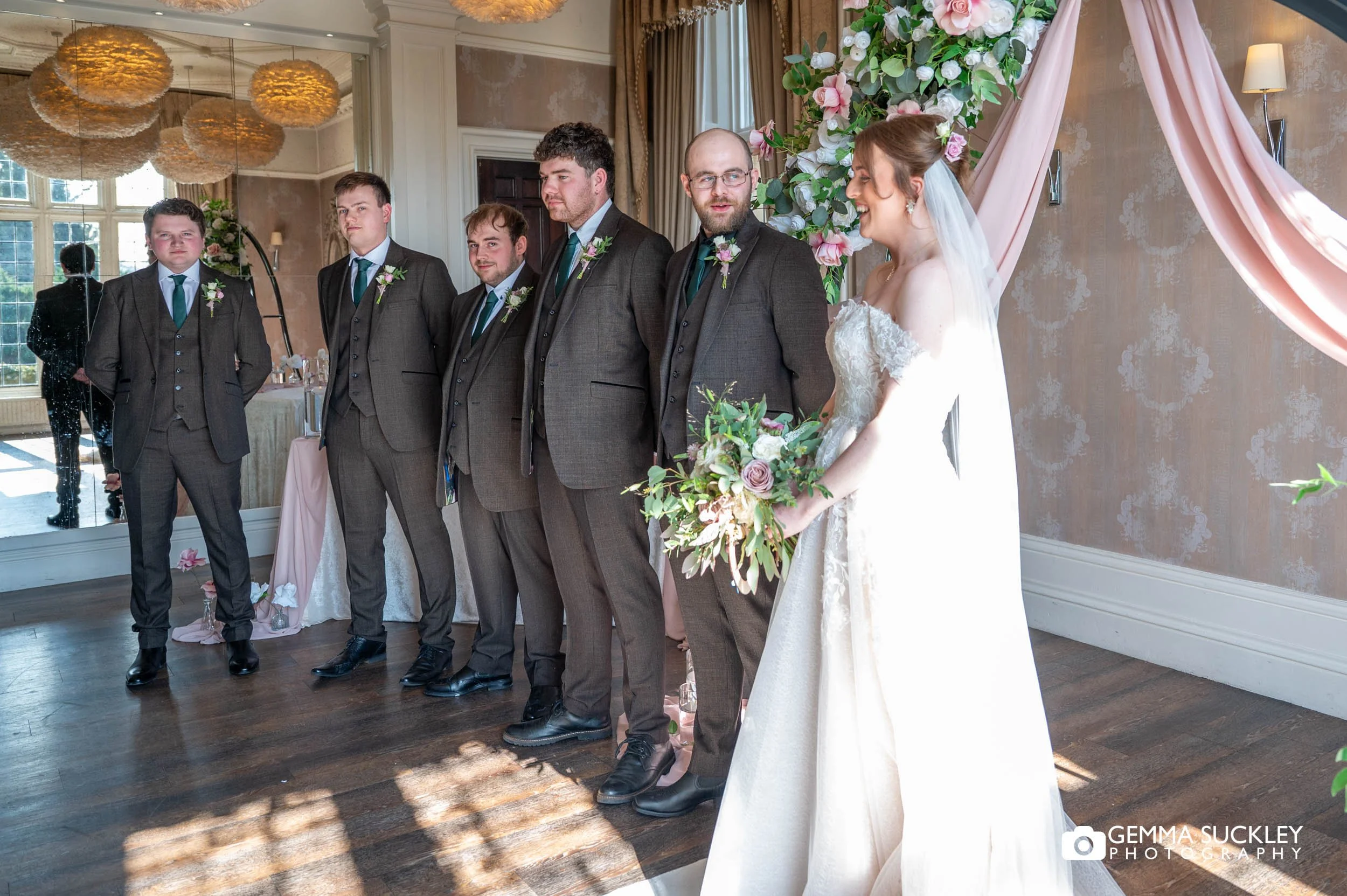 Groom reacting as bride walks down the aisle at Falcon Manor