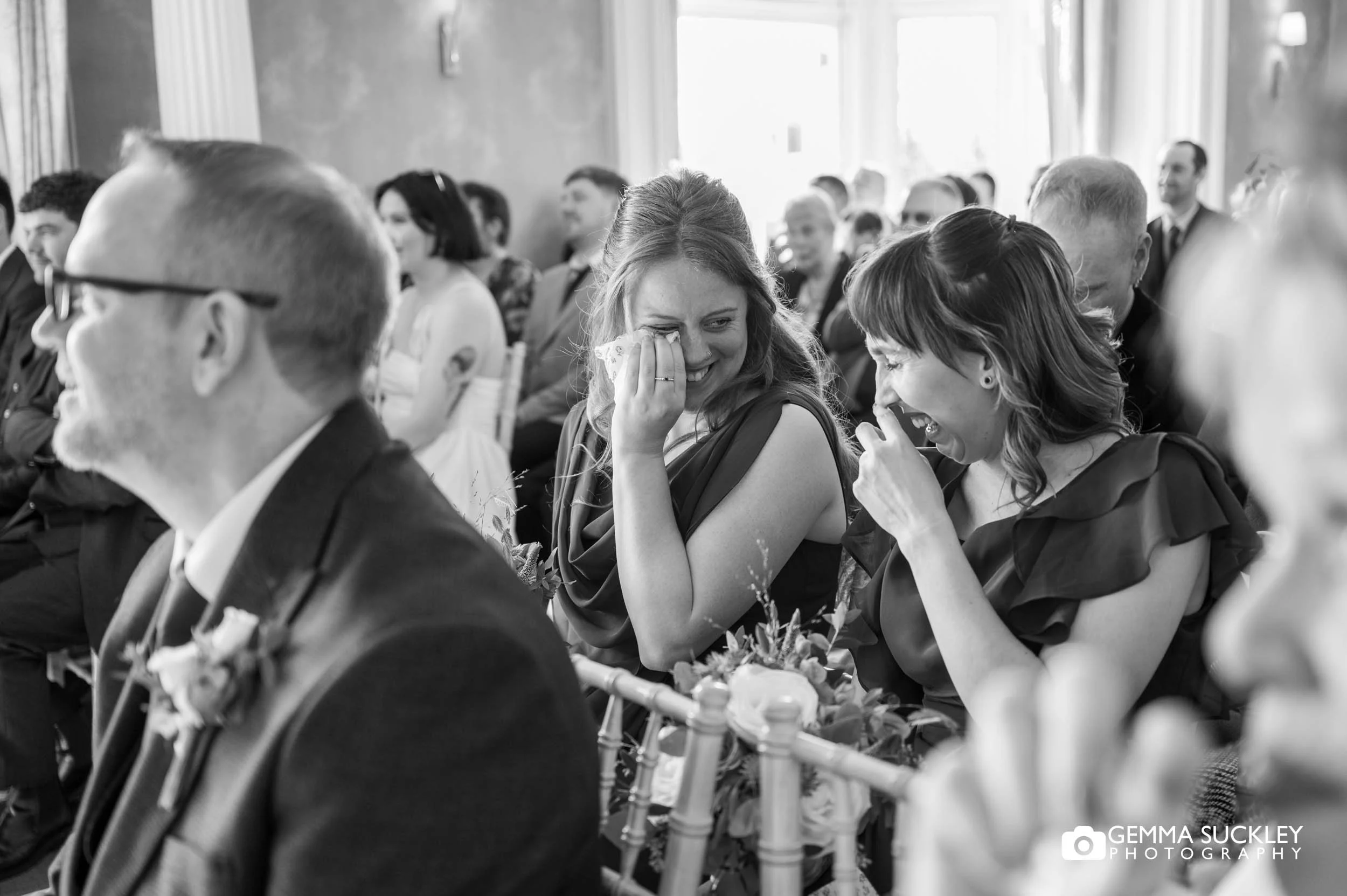 guests laughing during the ceremony at the falcon manor