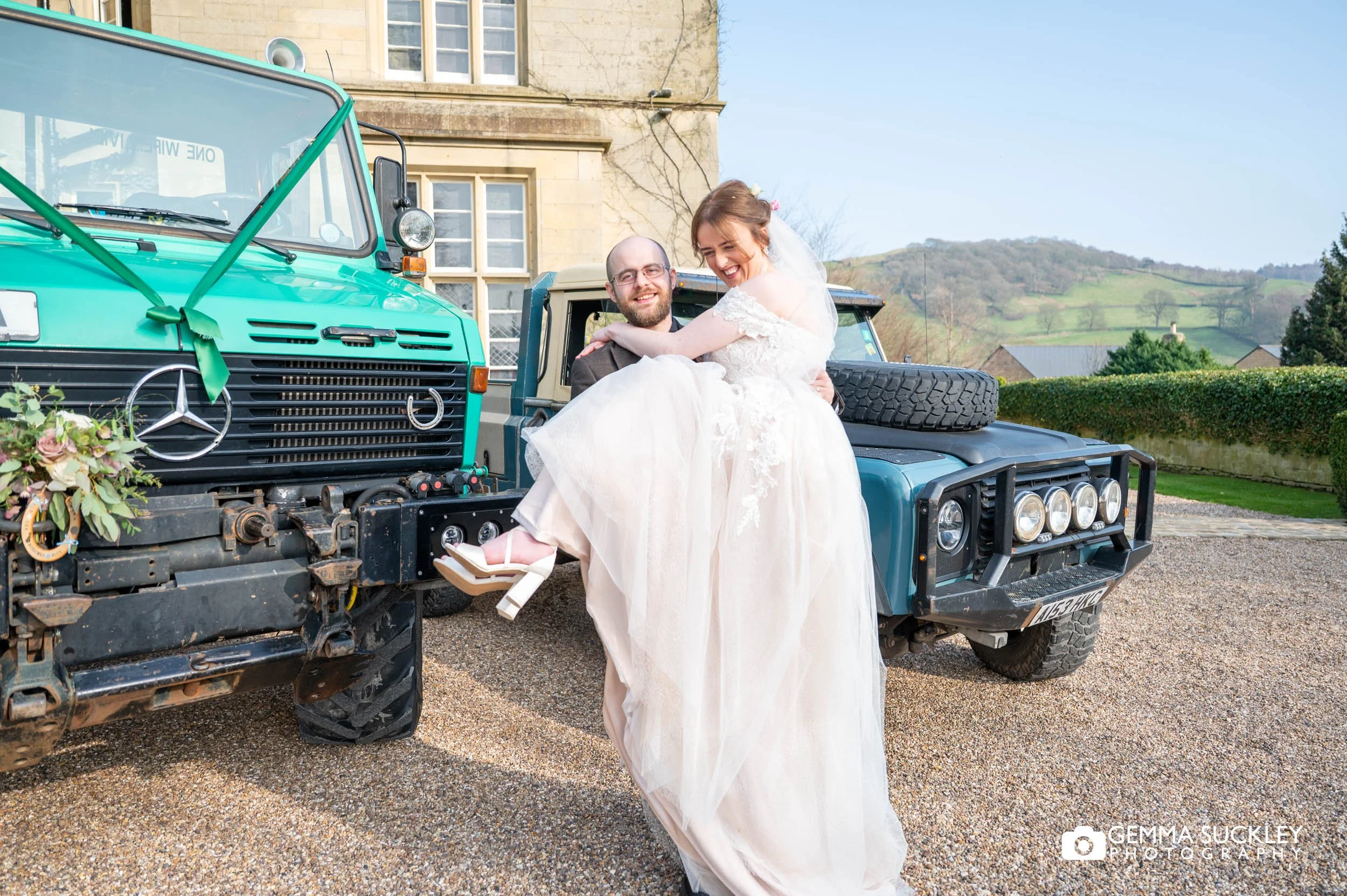 groom lifting the bride from the Unimog at Falcon Manor Settle wedding
