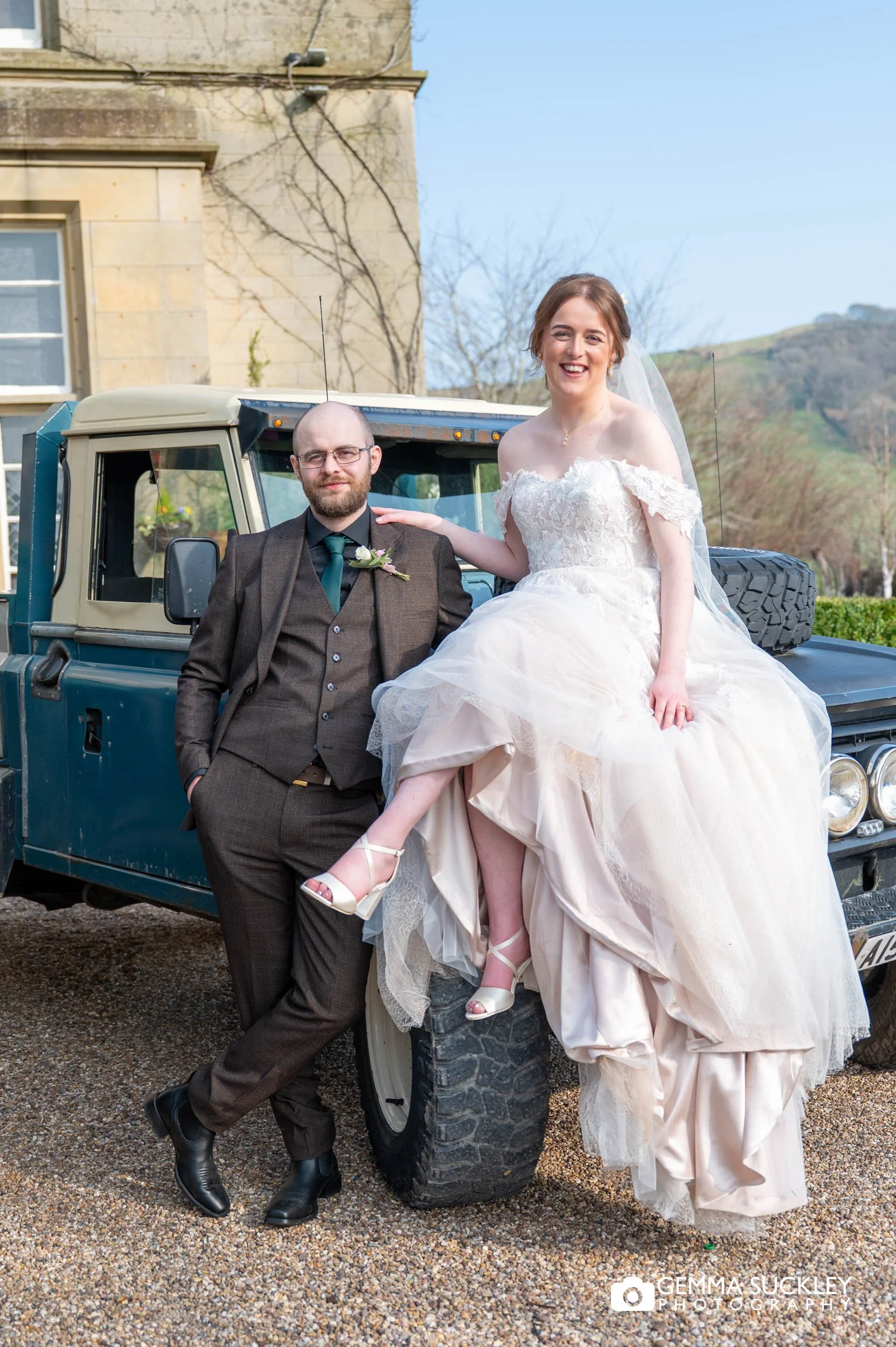 bride sat on the land rover outside the falcon manor