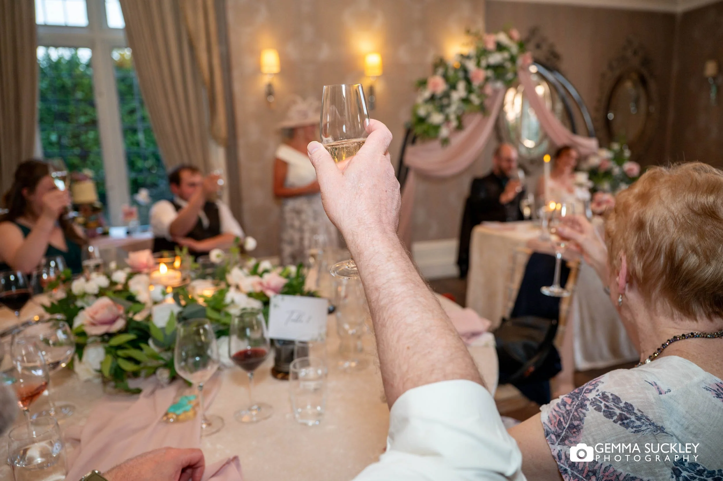 Guests laughing during wedding speeches at Falcon Manor