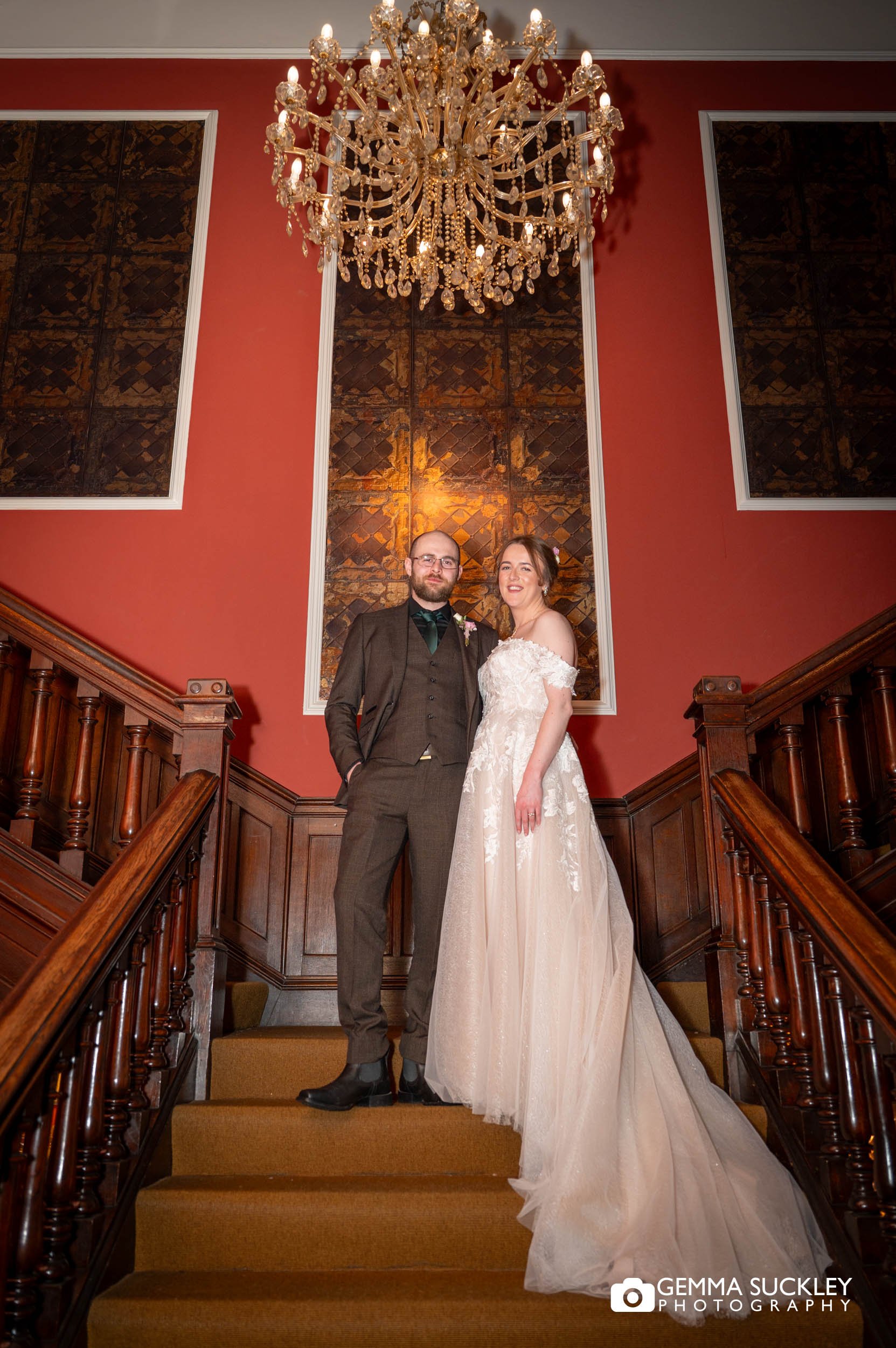 Couple laughing during relaxed portraits on the Falcon Manor staircase
