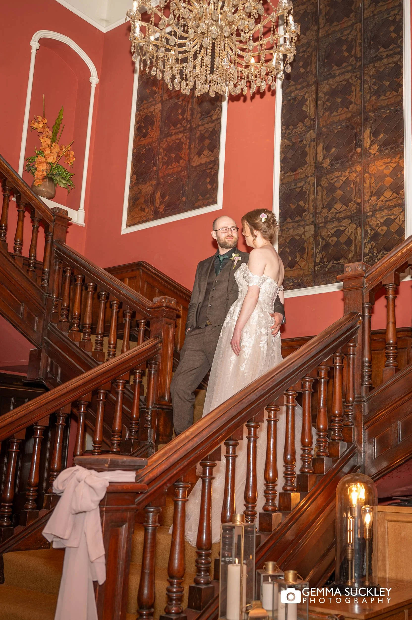 Couple laughing during relaxed portraits on the staircase at the Falcon Manor